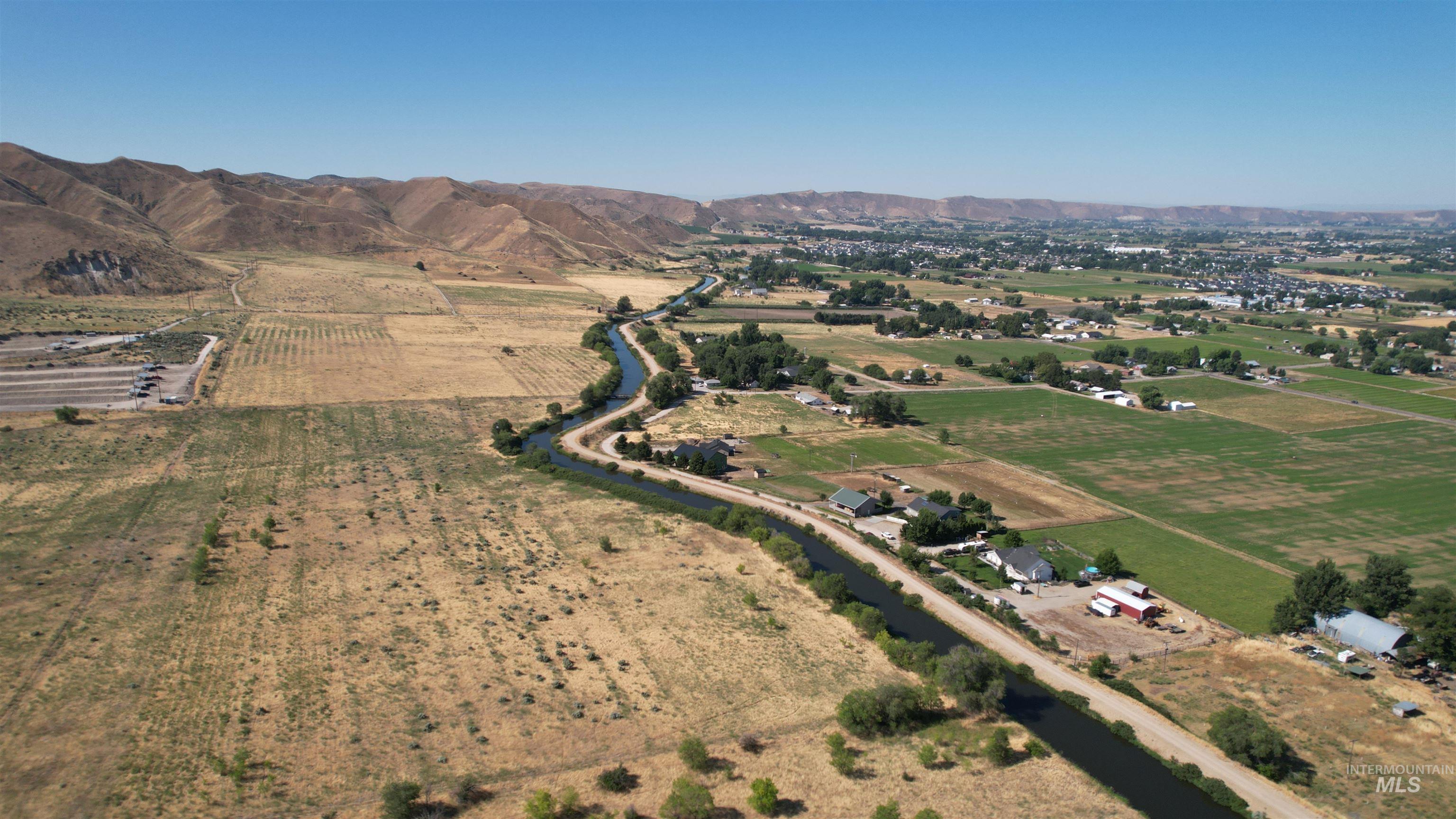 Aerial overview of property's location featuring rural landscape, farmland, and mountains
