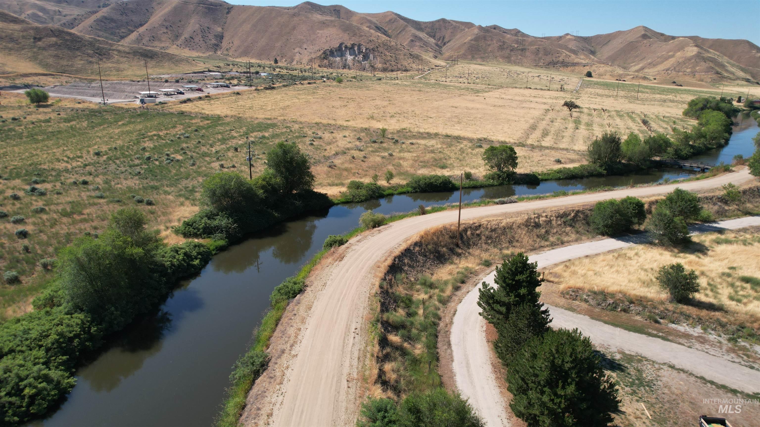 View of property location featuring rural landscape and a water and mountain view