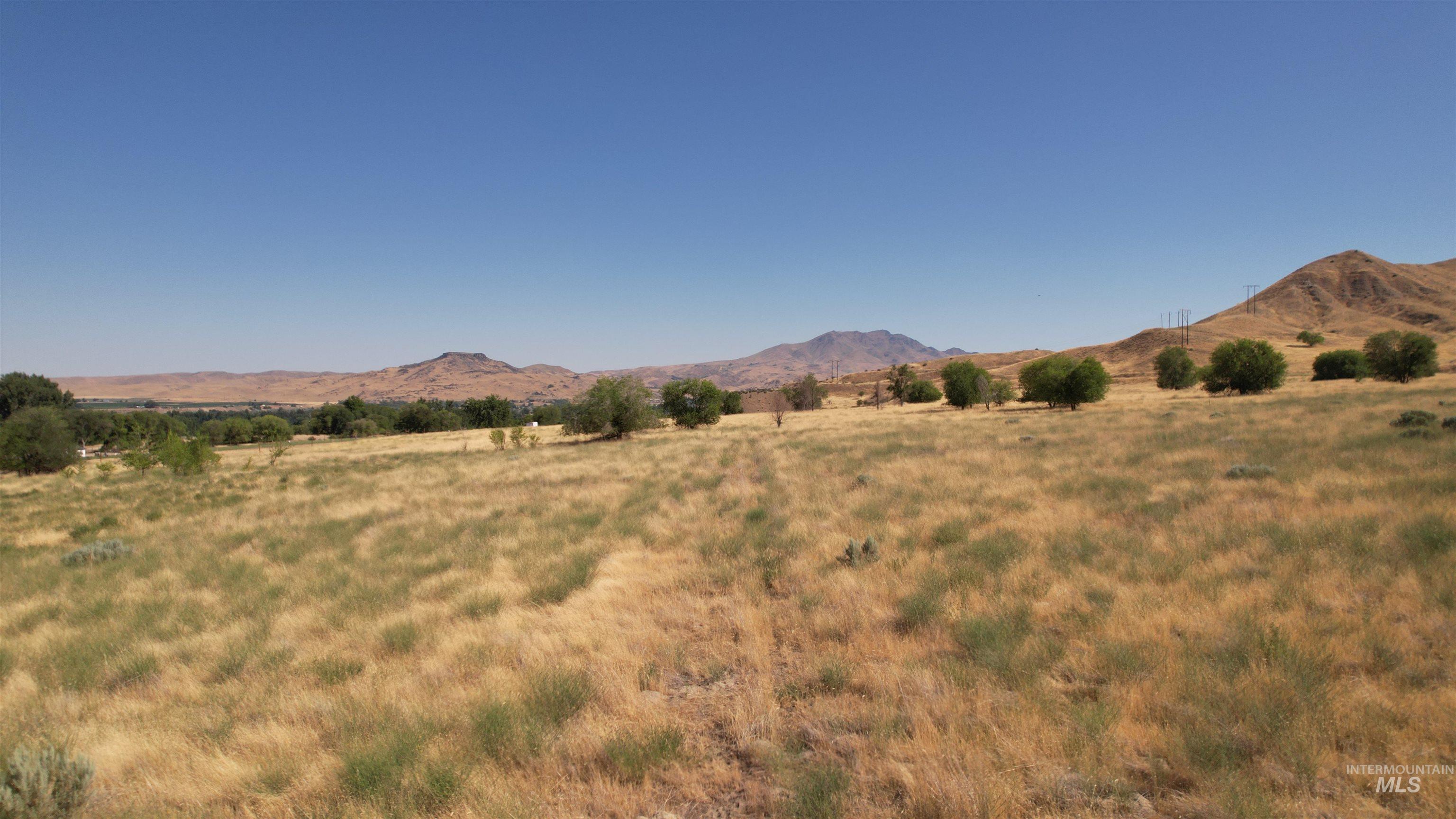 View of mountain backdrop featuring rural landscape