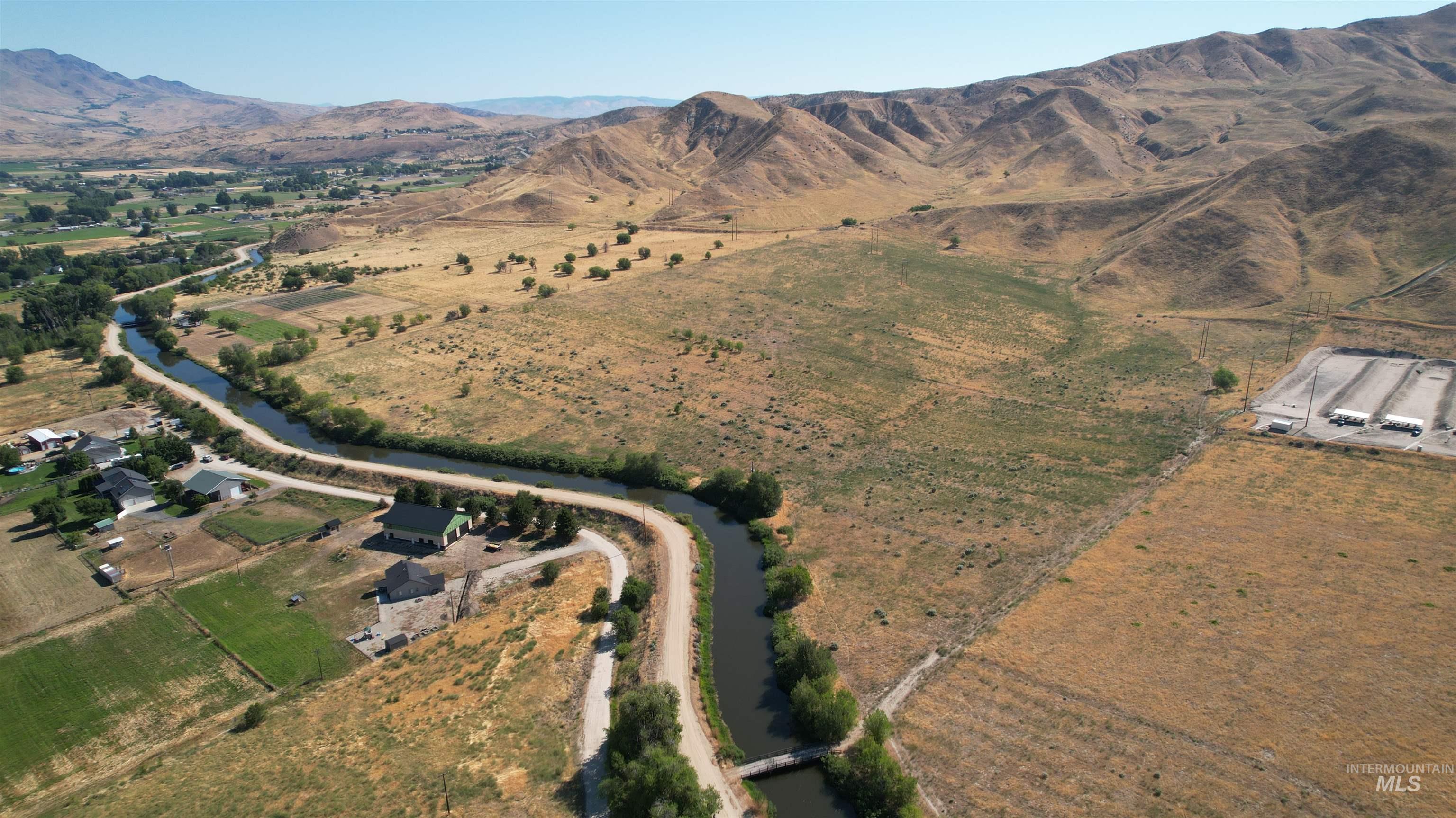 Aerial overview of property's location with rural landscape and a water and mountain view