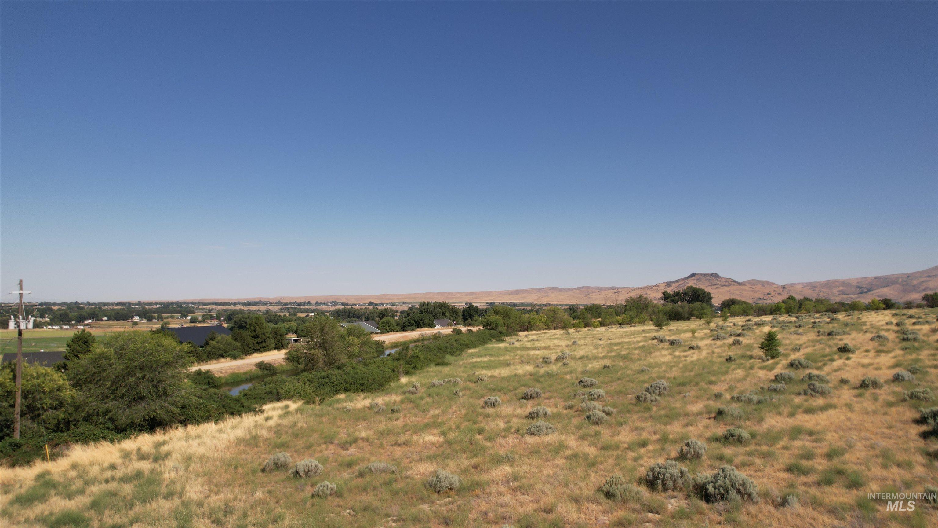 View of mountain backdrop with rural landscape