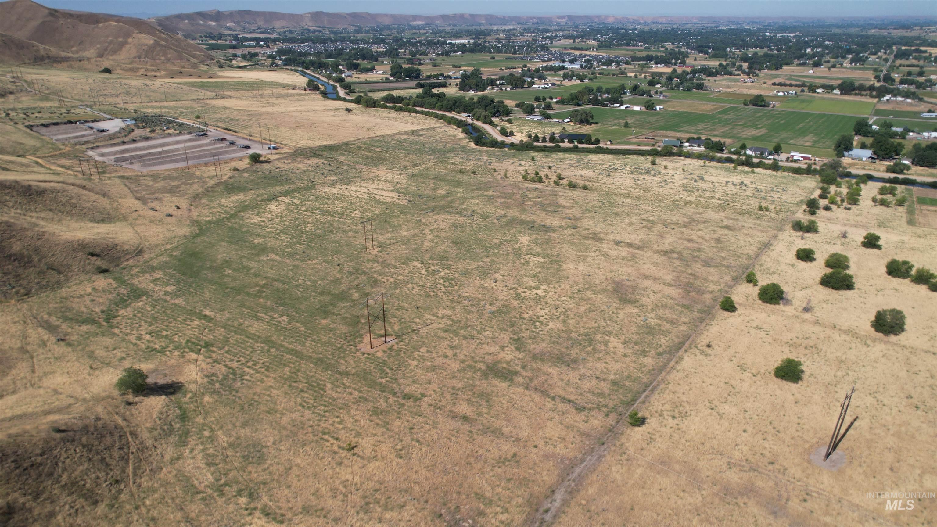 Aerial overview of property's location with rural landscape and large plots for crops