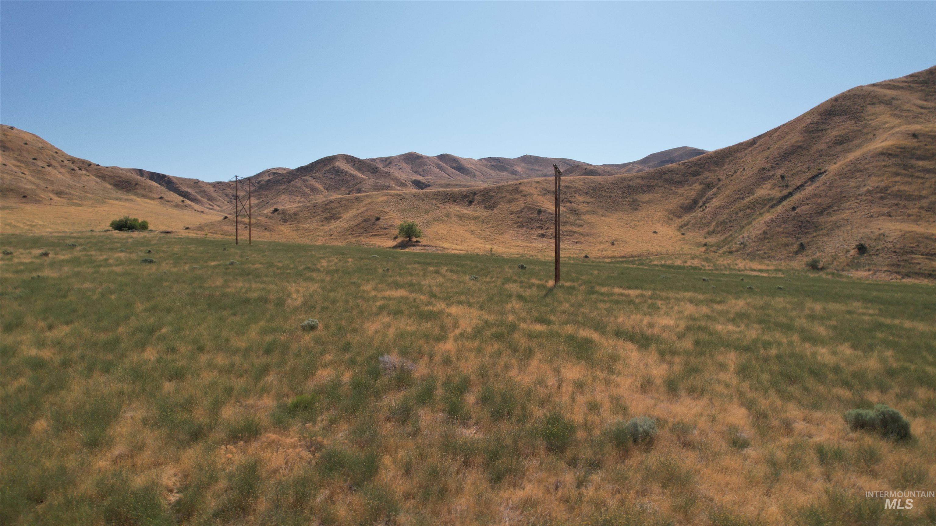View of mountain backdrop featuring rural landscape