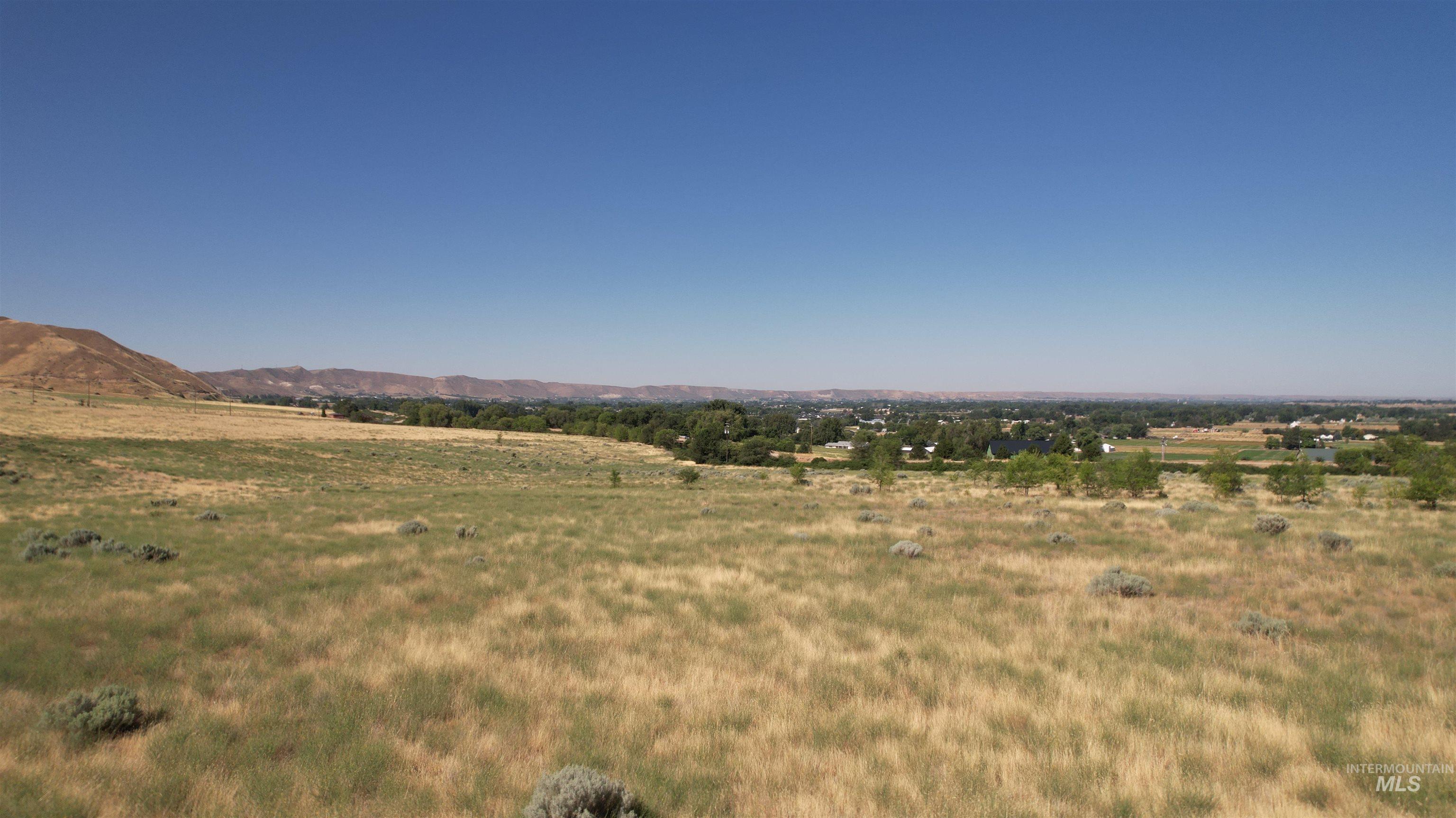 View of mountain backdrop featuring rural landscape