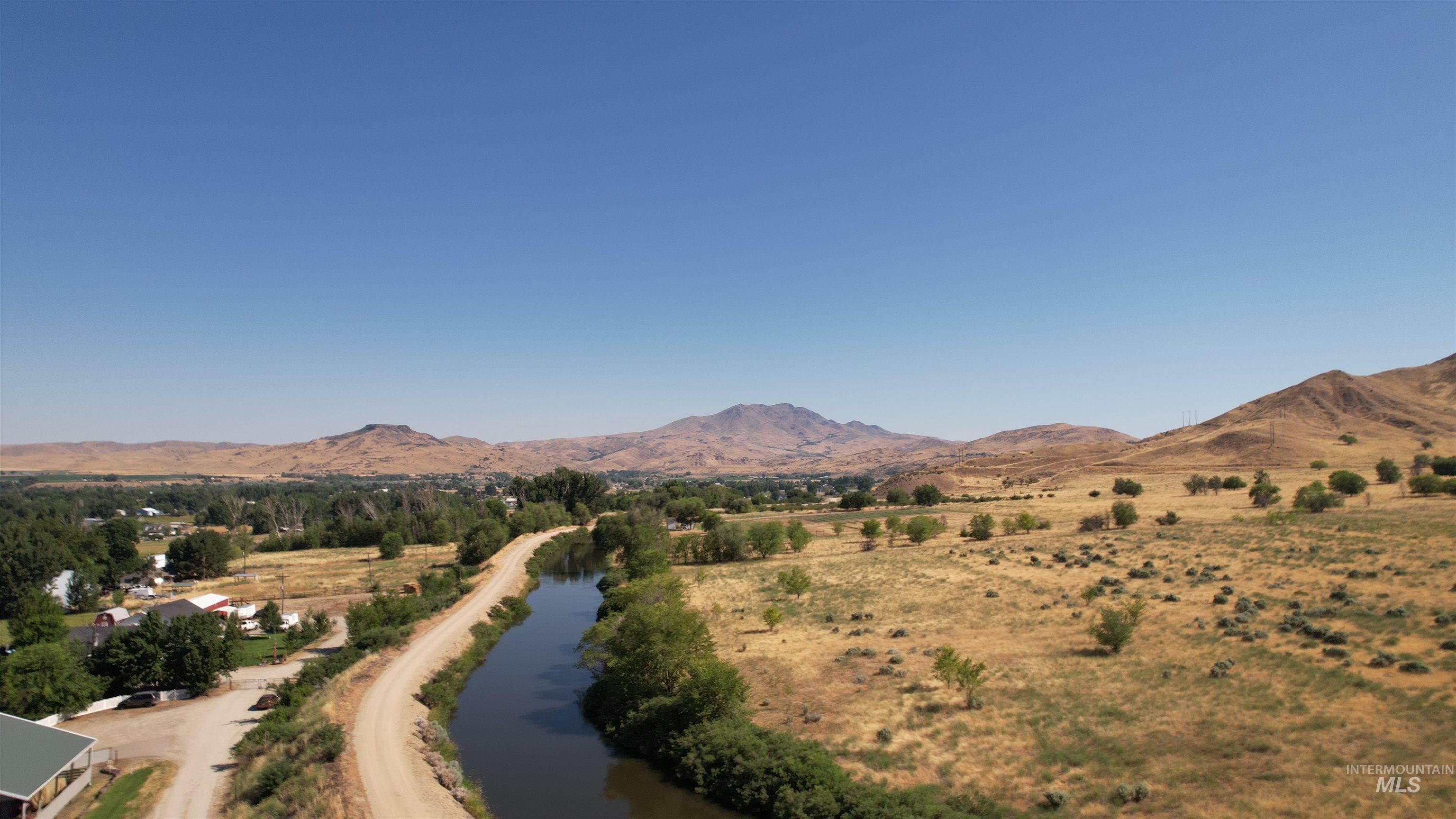 View of mountain background featuring a large body of water and rural landscape