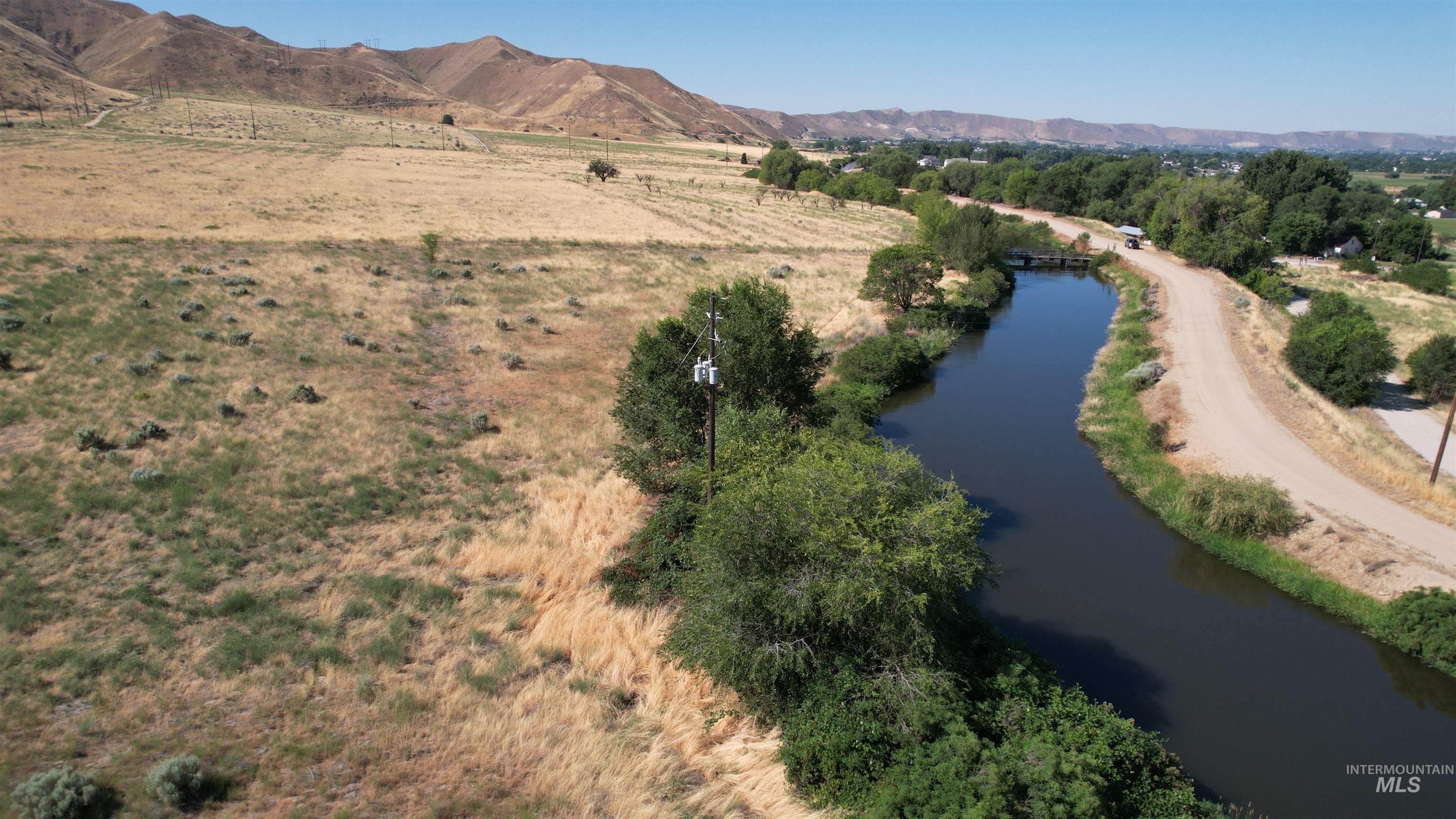 View of property location with rural landscape and a water and mountain view