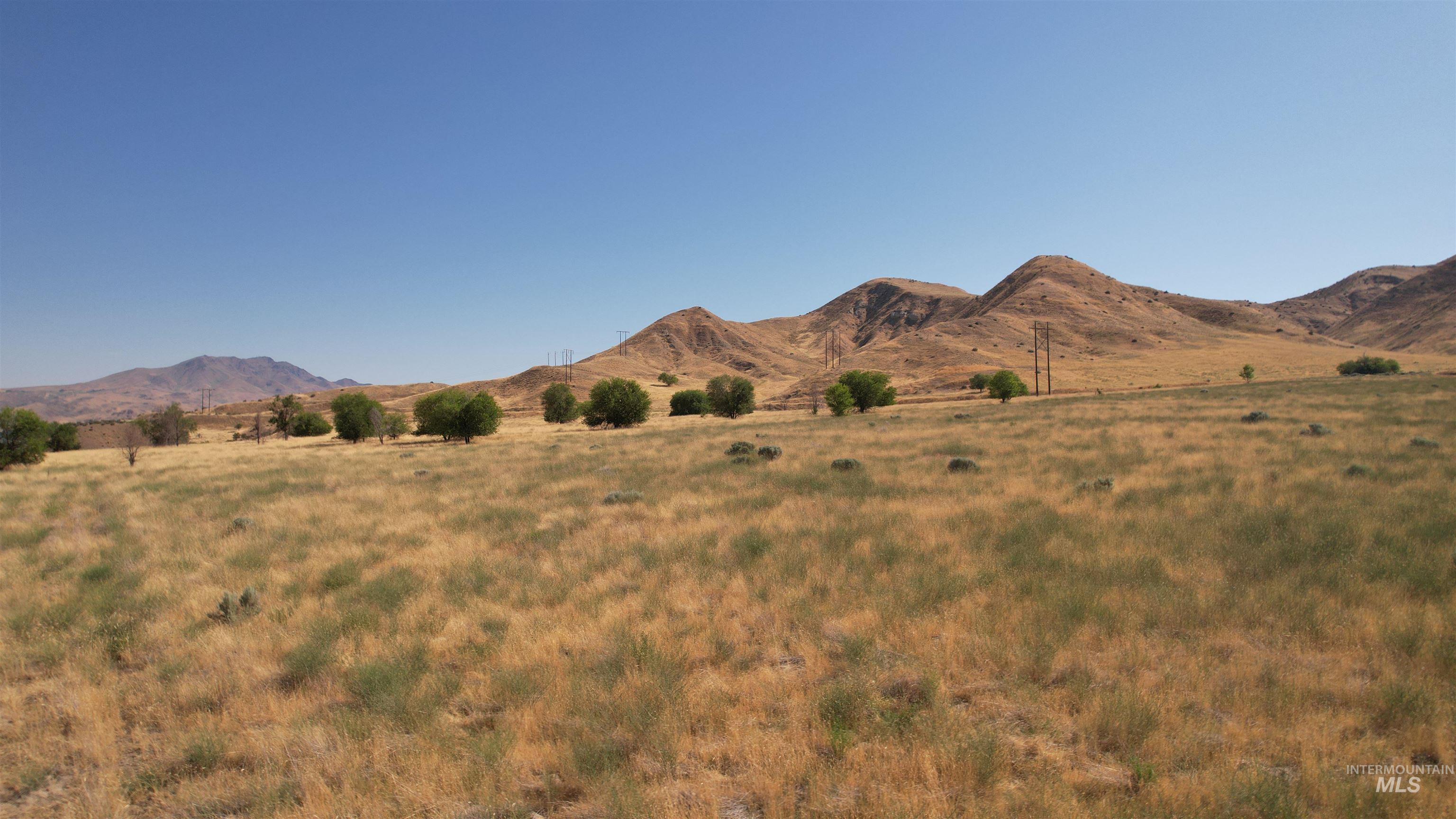 View of mountain backdrop featuring rural landscape
