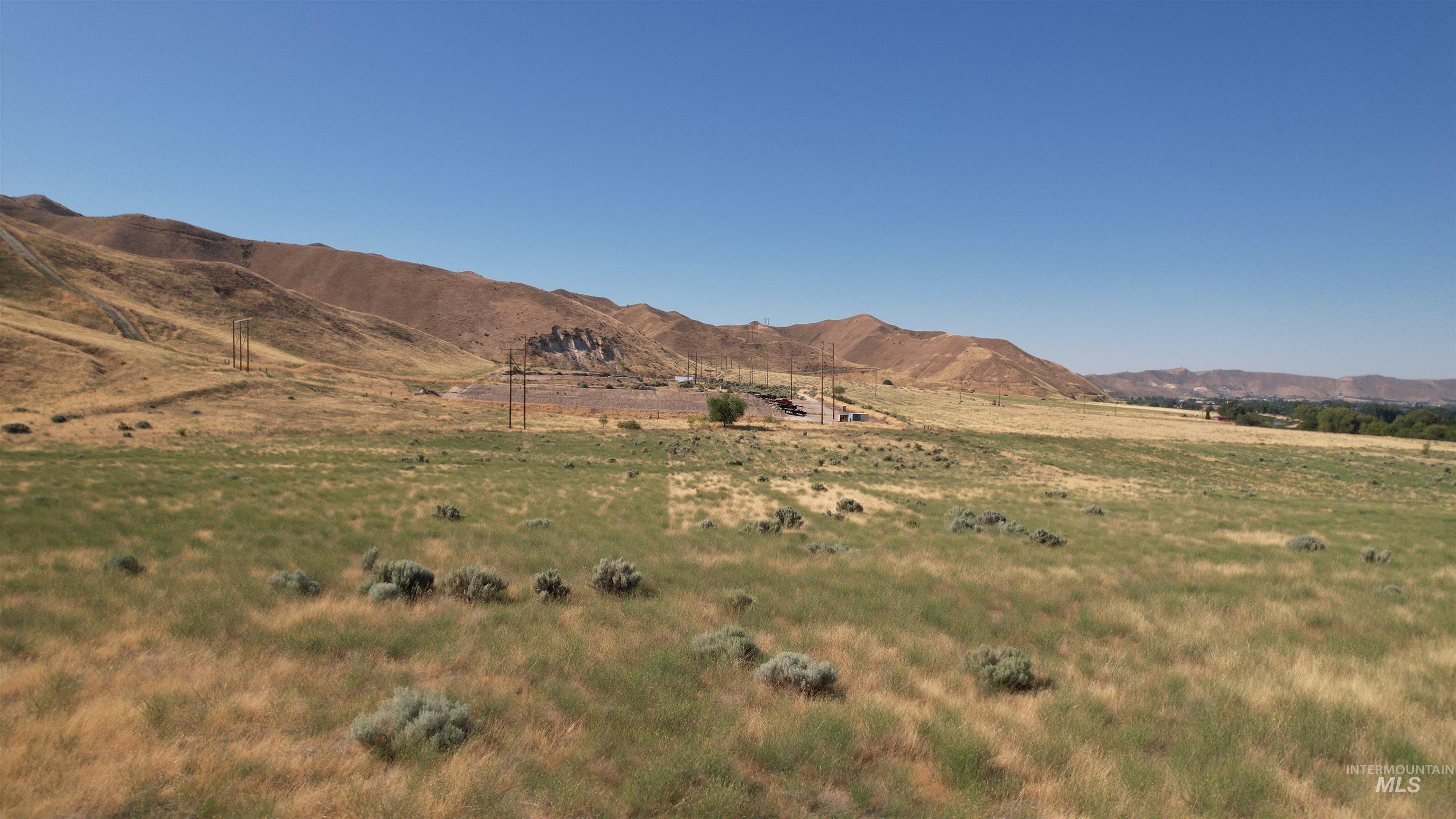 View of mountain backdrop featuring rural landscape