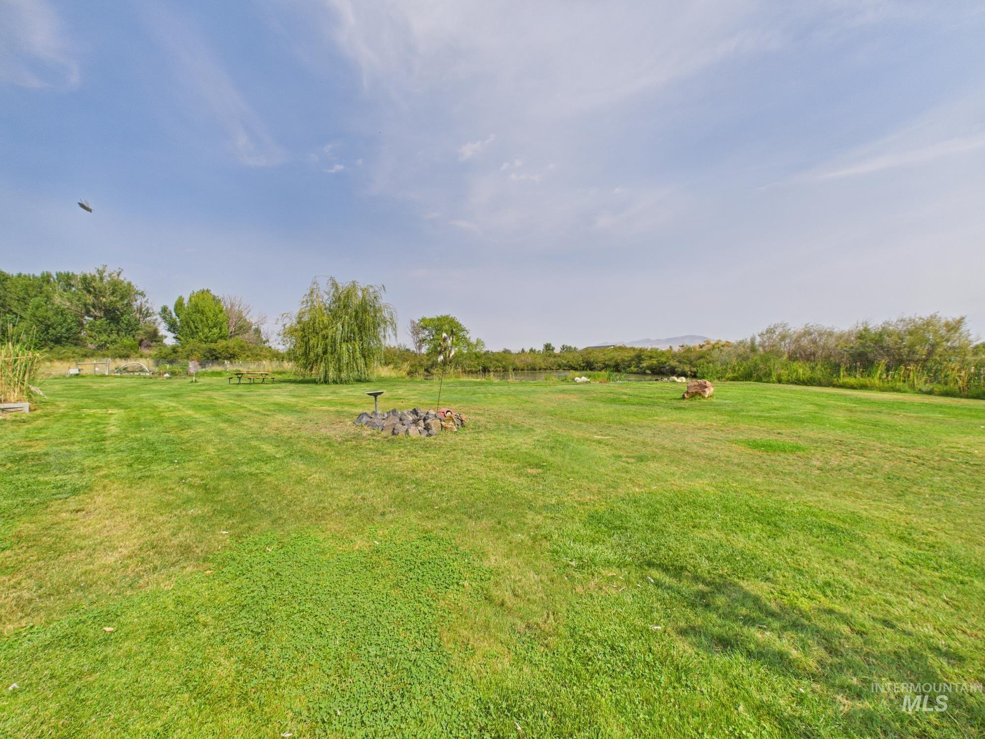 View of green lawn with a rural view