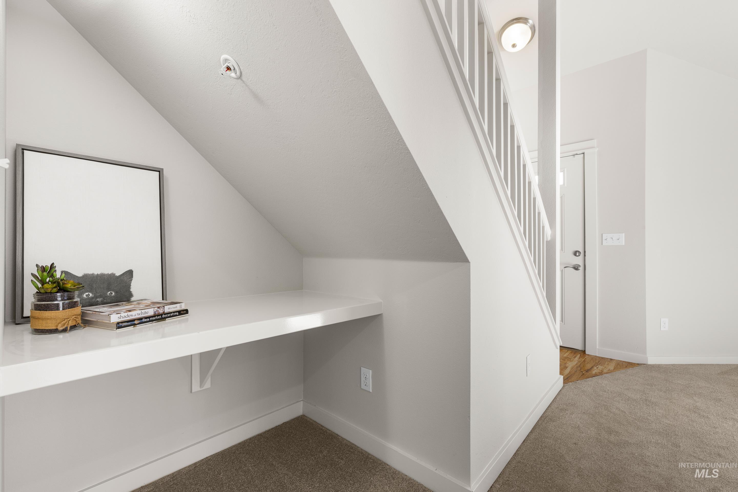 Unfurnished office with light carpet and lofted ceiling