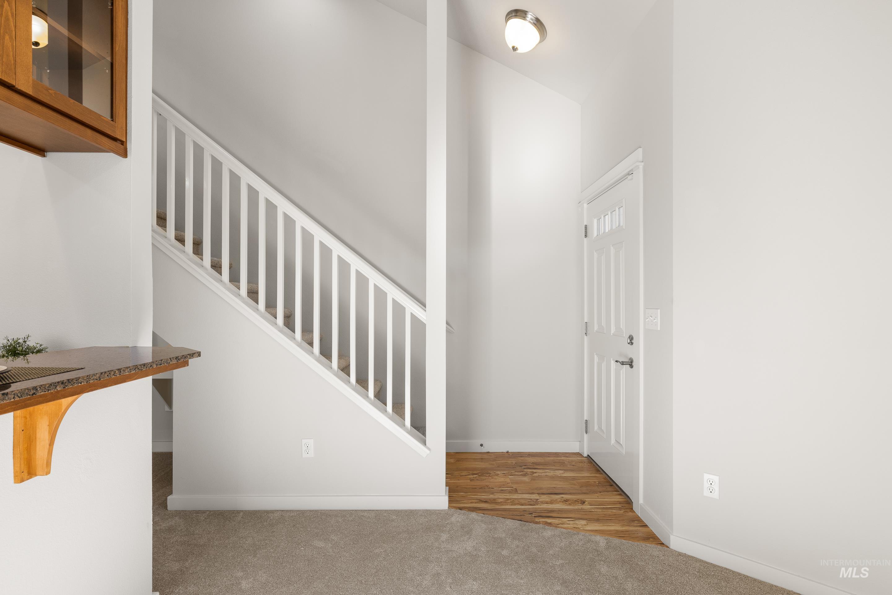 Stairs featuring carpet flooring and baseboards