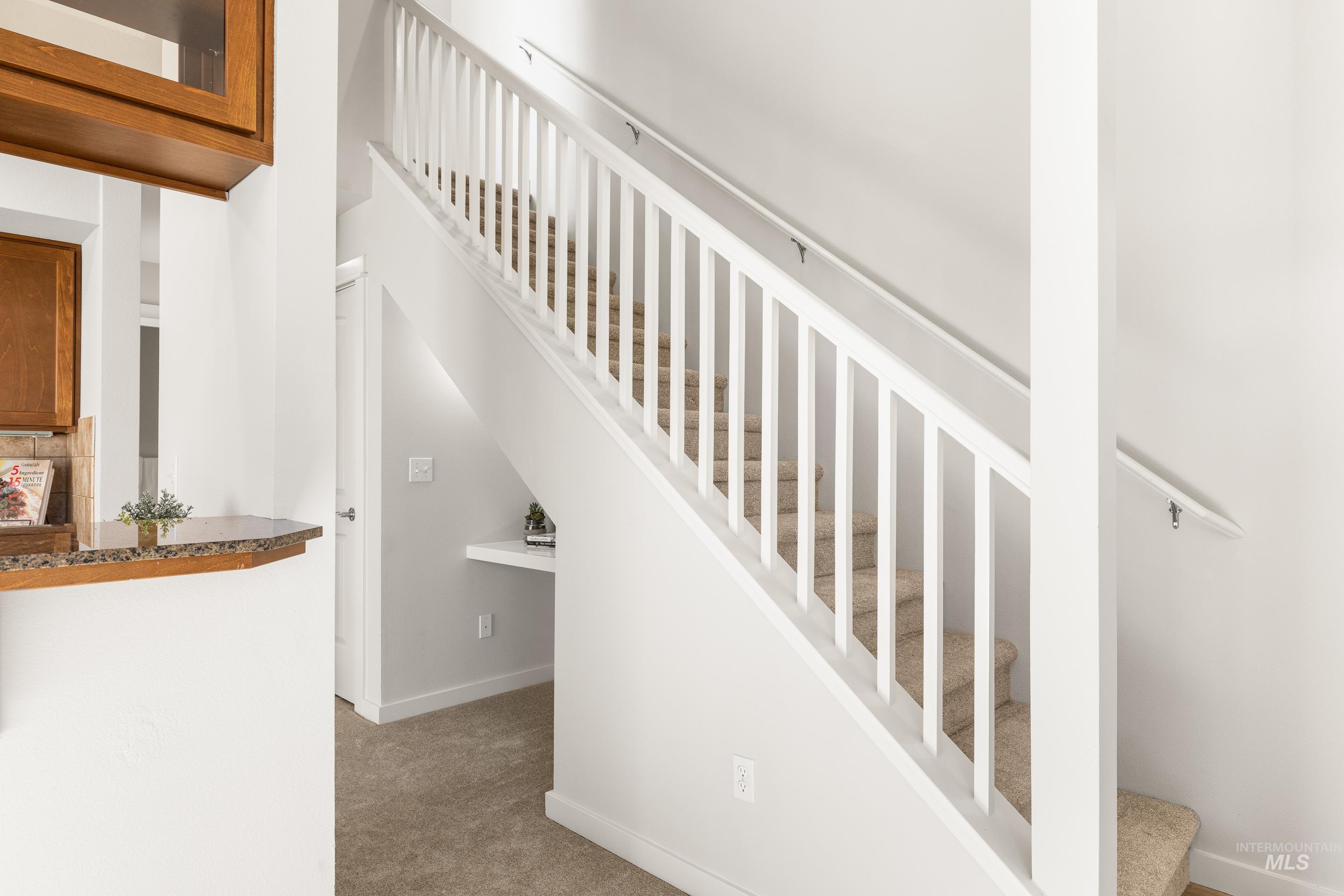 Stairway featuring carpet floors and baseboards