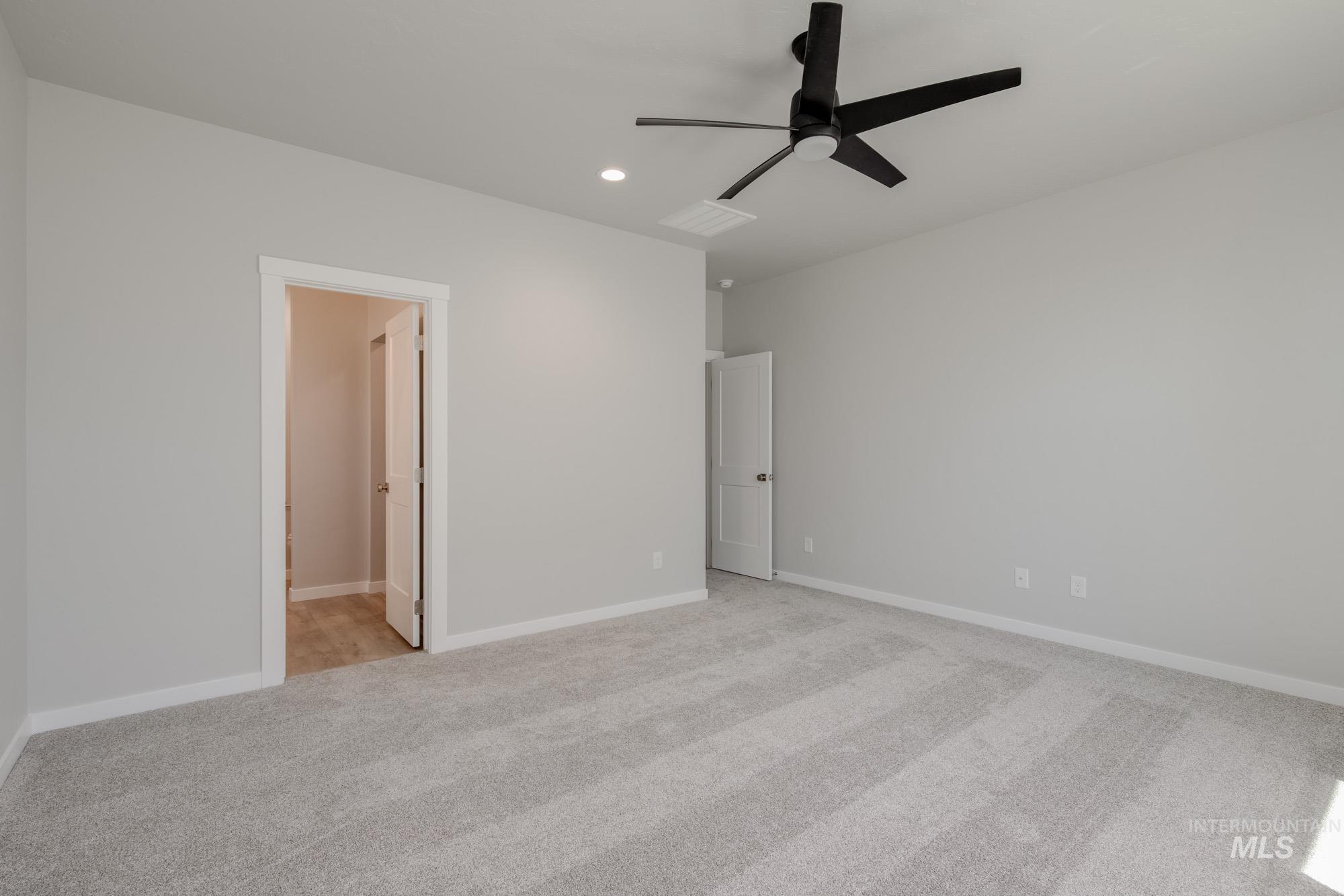 Unfurnished bedroom featuring light carpet, recessed lighting, and ceiling fan