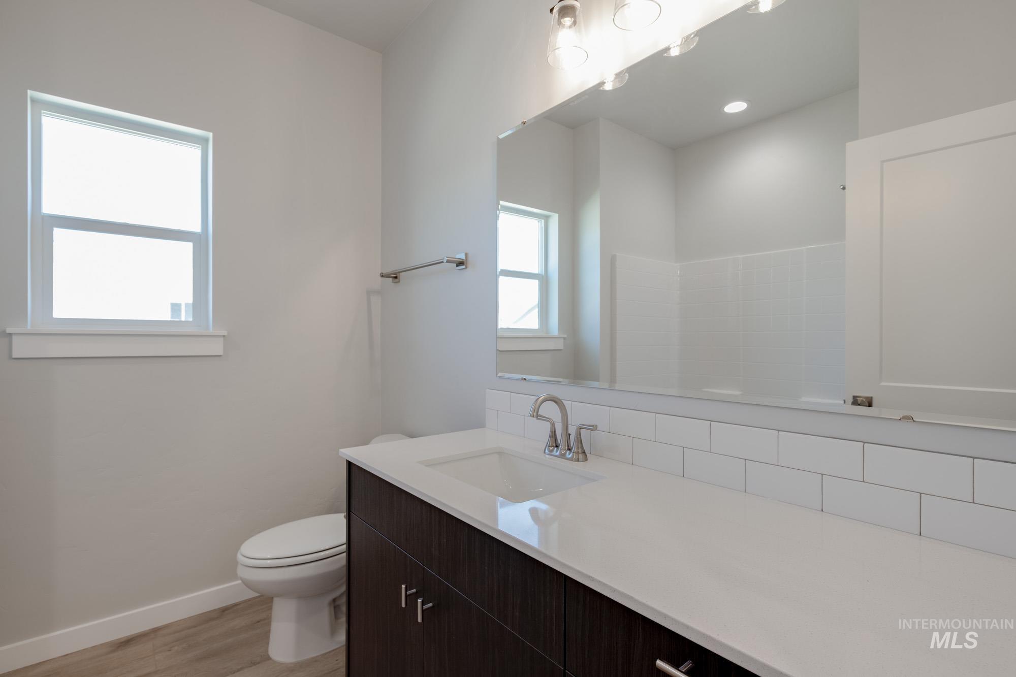 Bathroom with wood finished floors and vanity