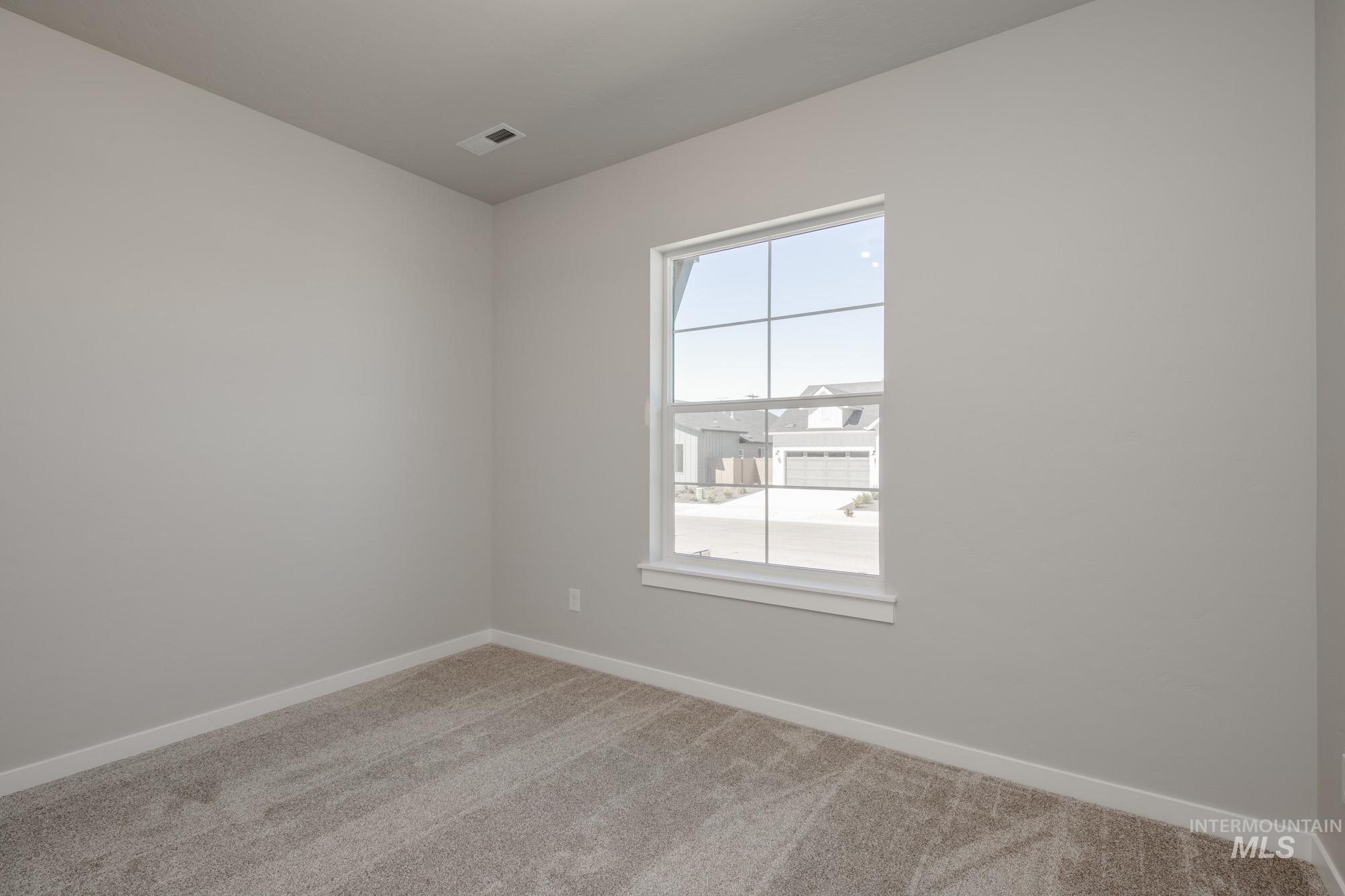 Empty room with carpet flooring
