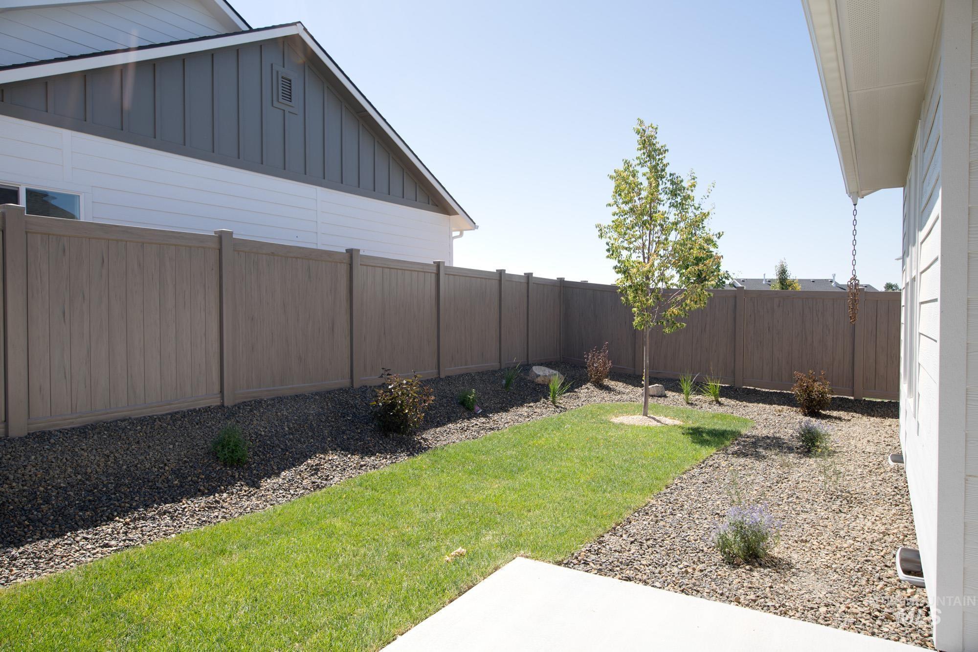 Fenced backyard with a patio area