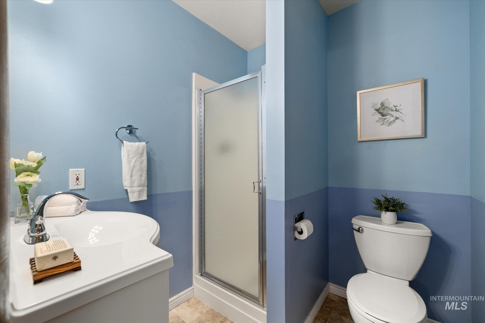 Bathroom with a stall shower, vanity, and tile patterned floors