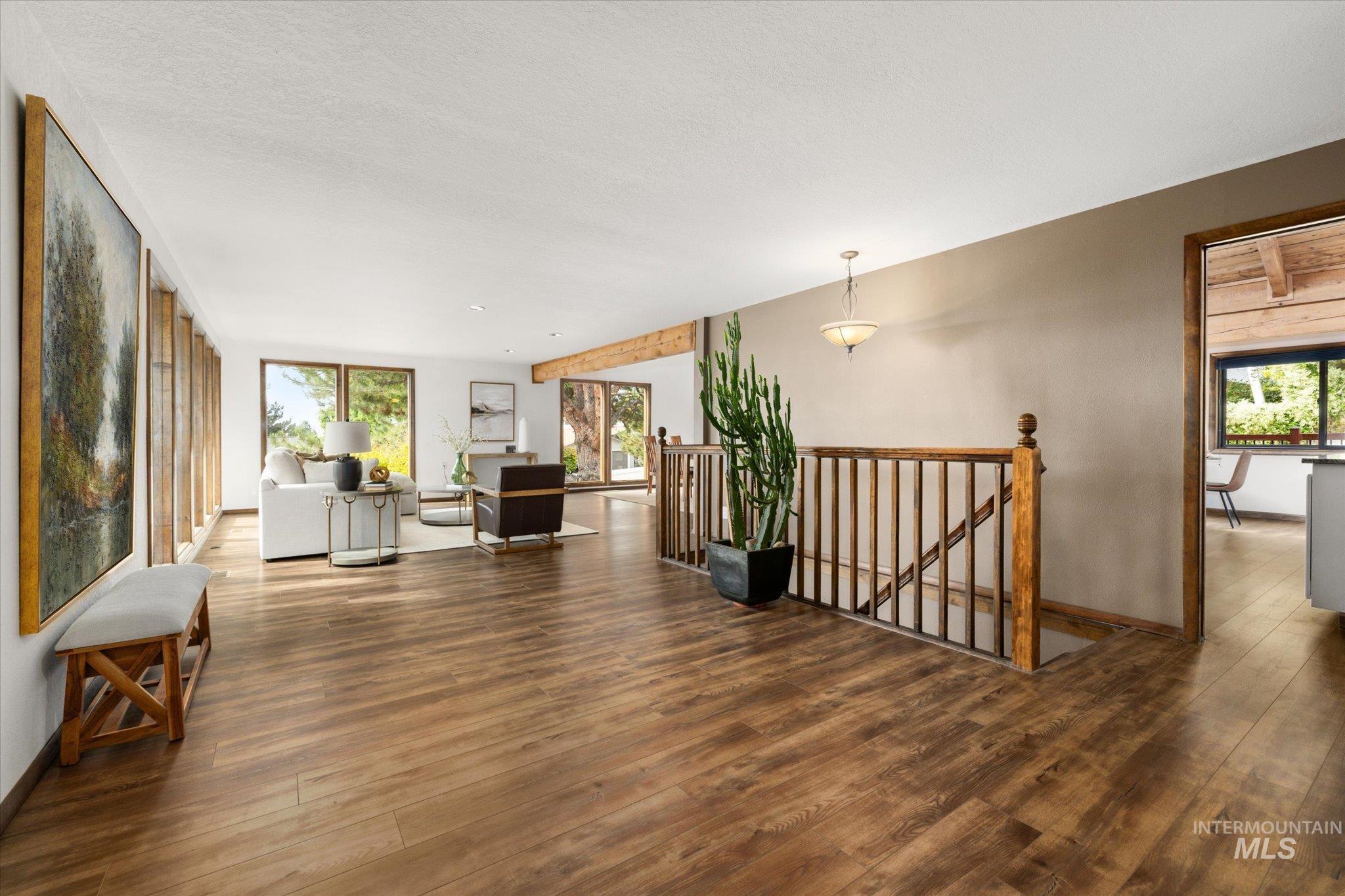 Hallway with an upstairs landing and wood finished floors