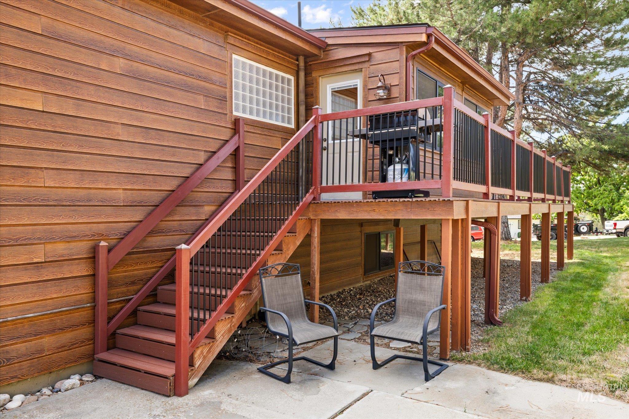 Property entrance with a deck and a patio