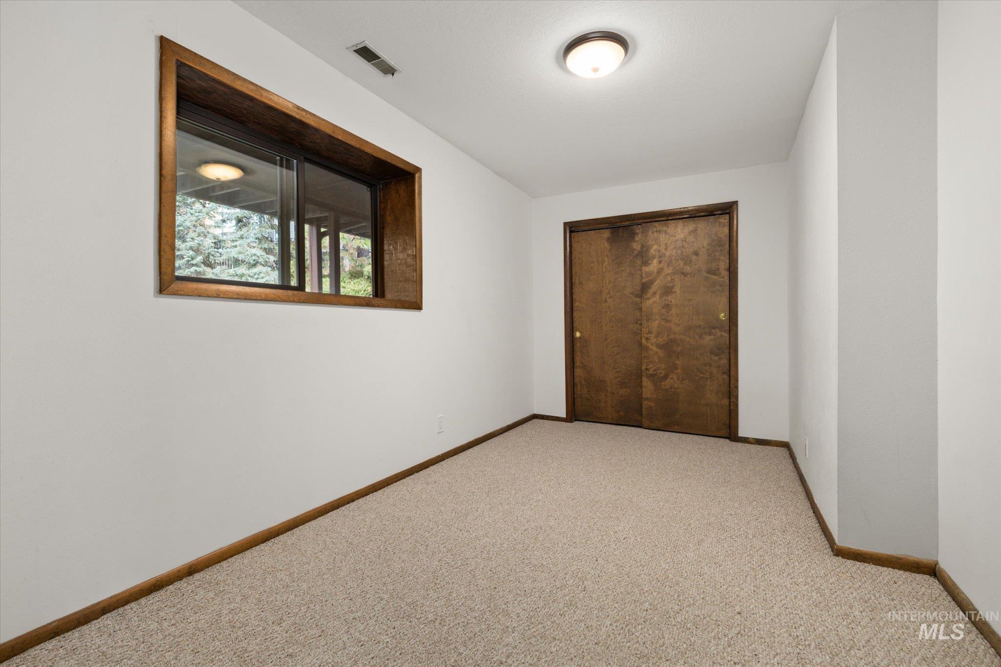 Unfurnished bedroom with carpet and a closet