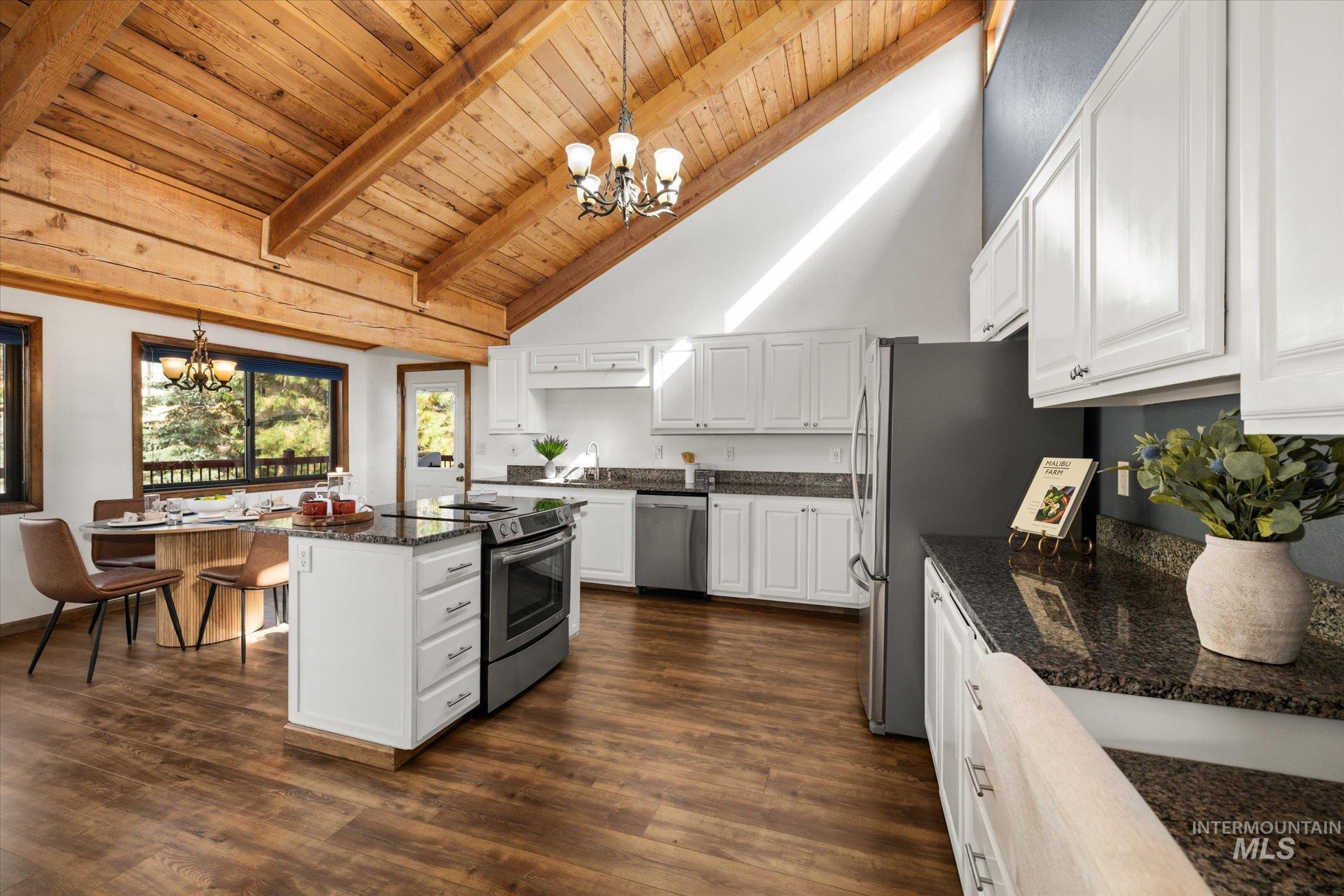 Kitchen featuring a chandelier, pendant lighting, white cabinets, a wood ceiling with exposed beams, and high vaulted ceiling