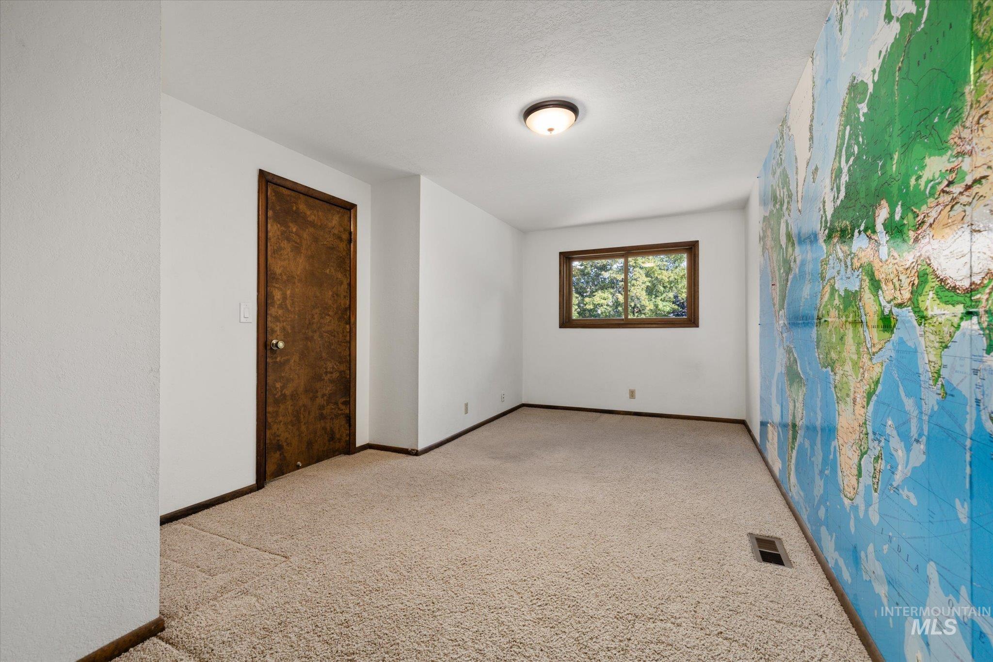 Unfurnished room with light colored carpet and baseboards