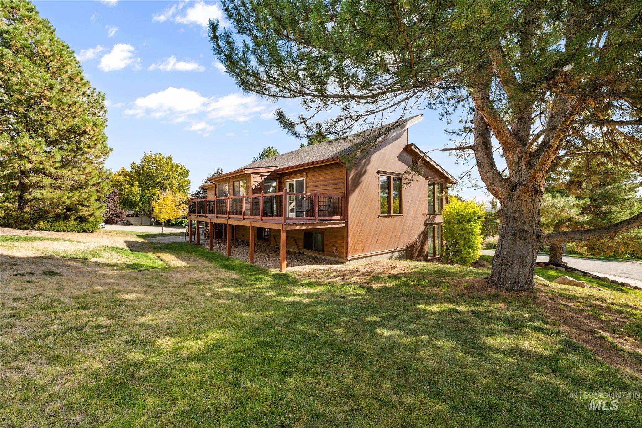 Back of property with a lawn and a deck