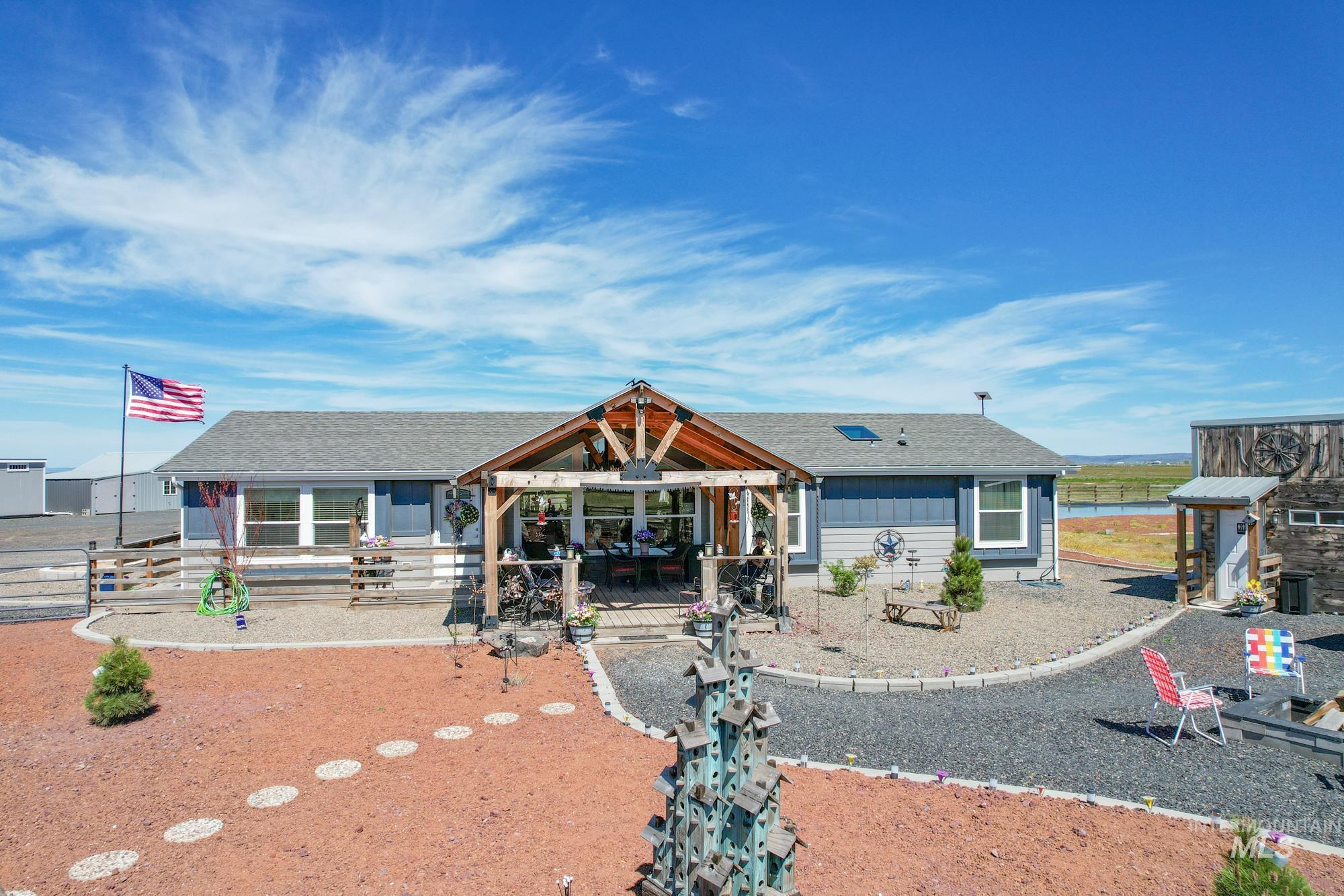 View of front of house with a gazebo and a shingled roof