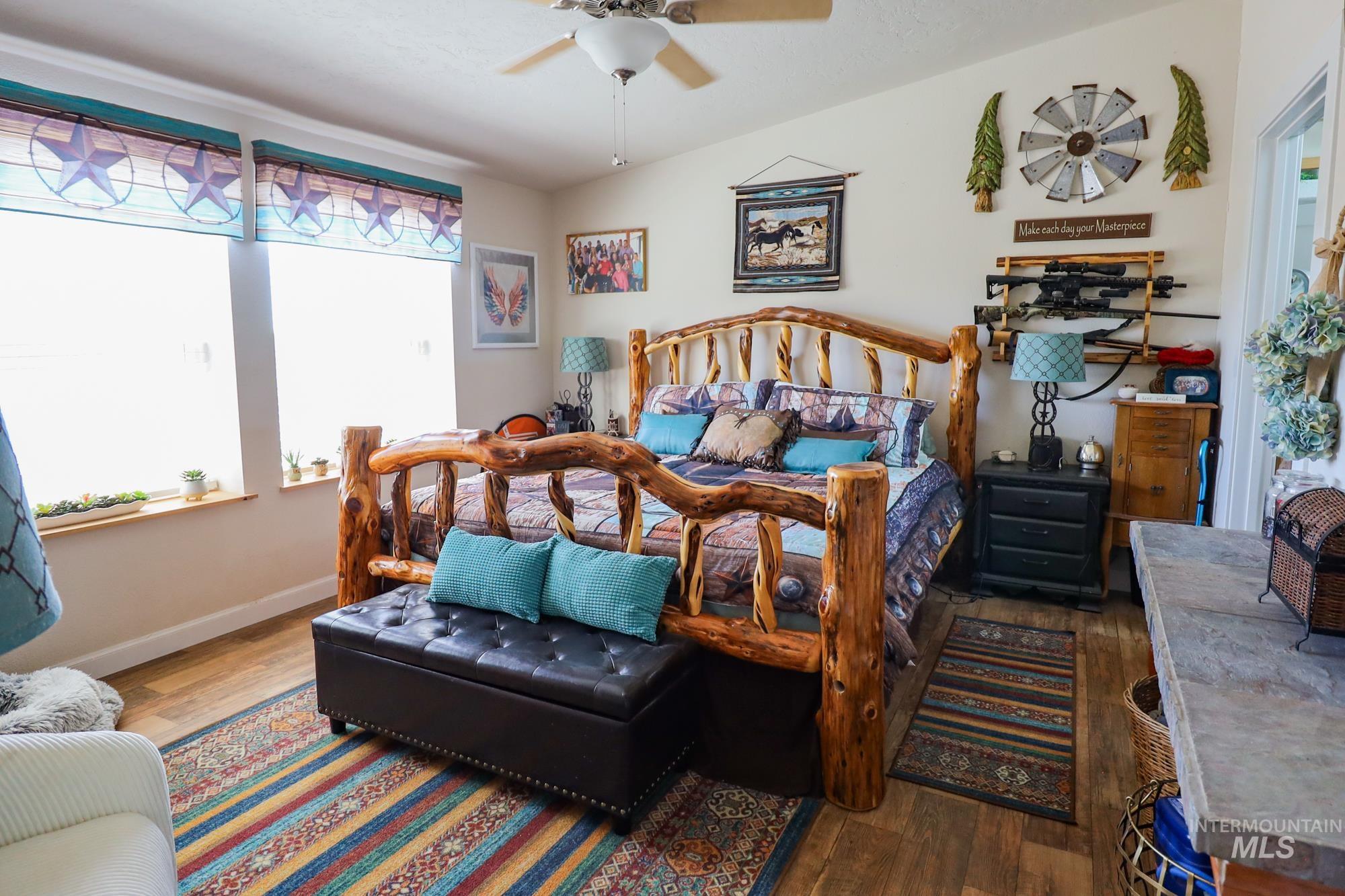 Bedroom featuring wood finished floors and a ceiling fan