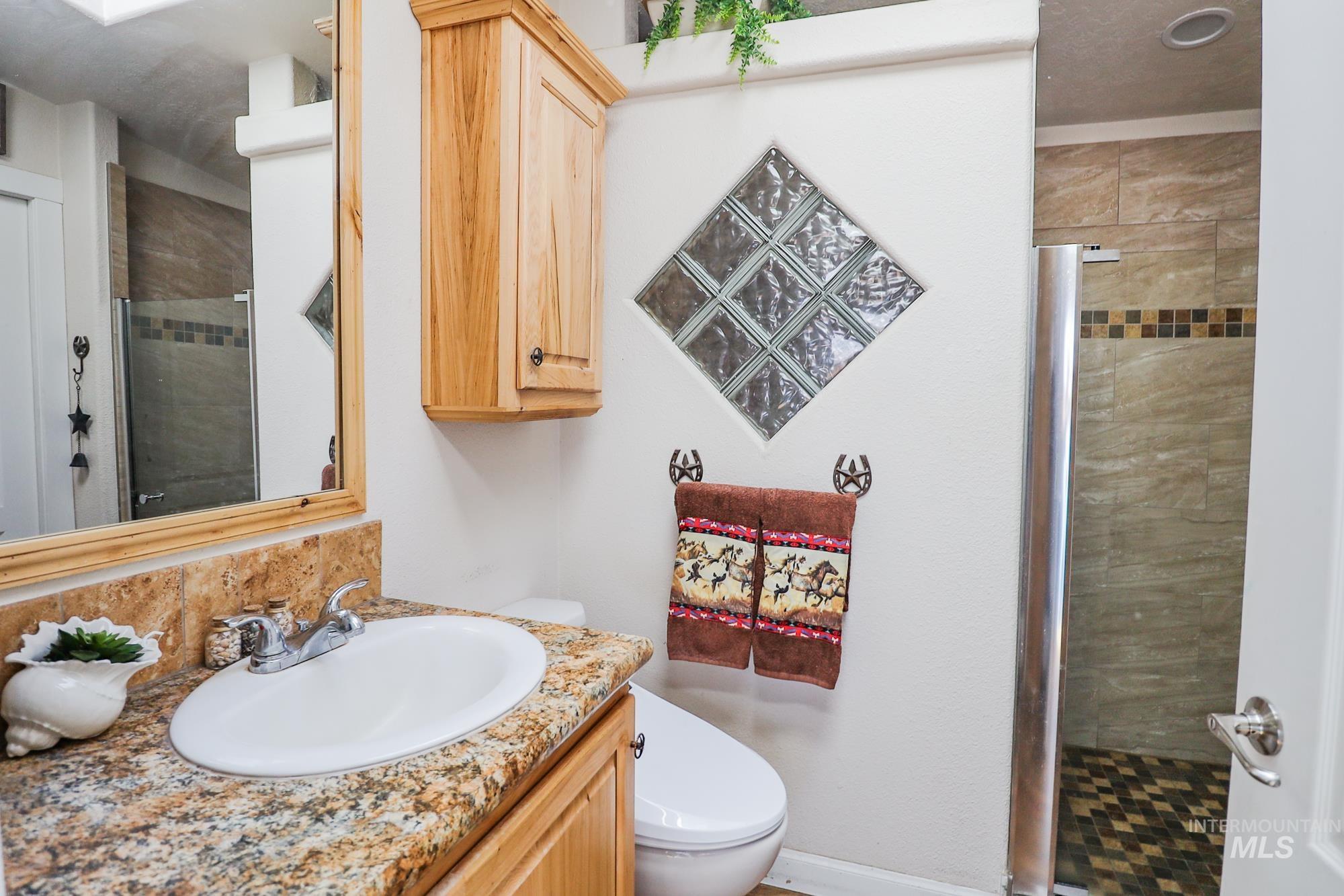 Bathroom with vanity and a stall shower