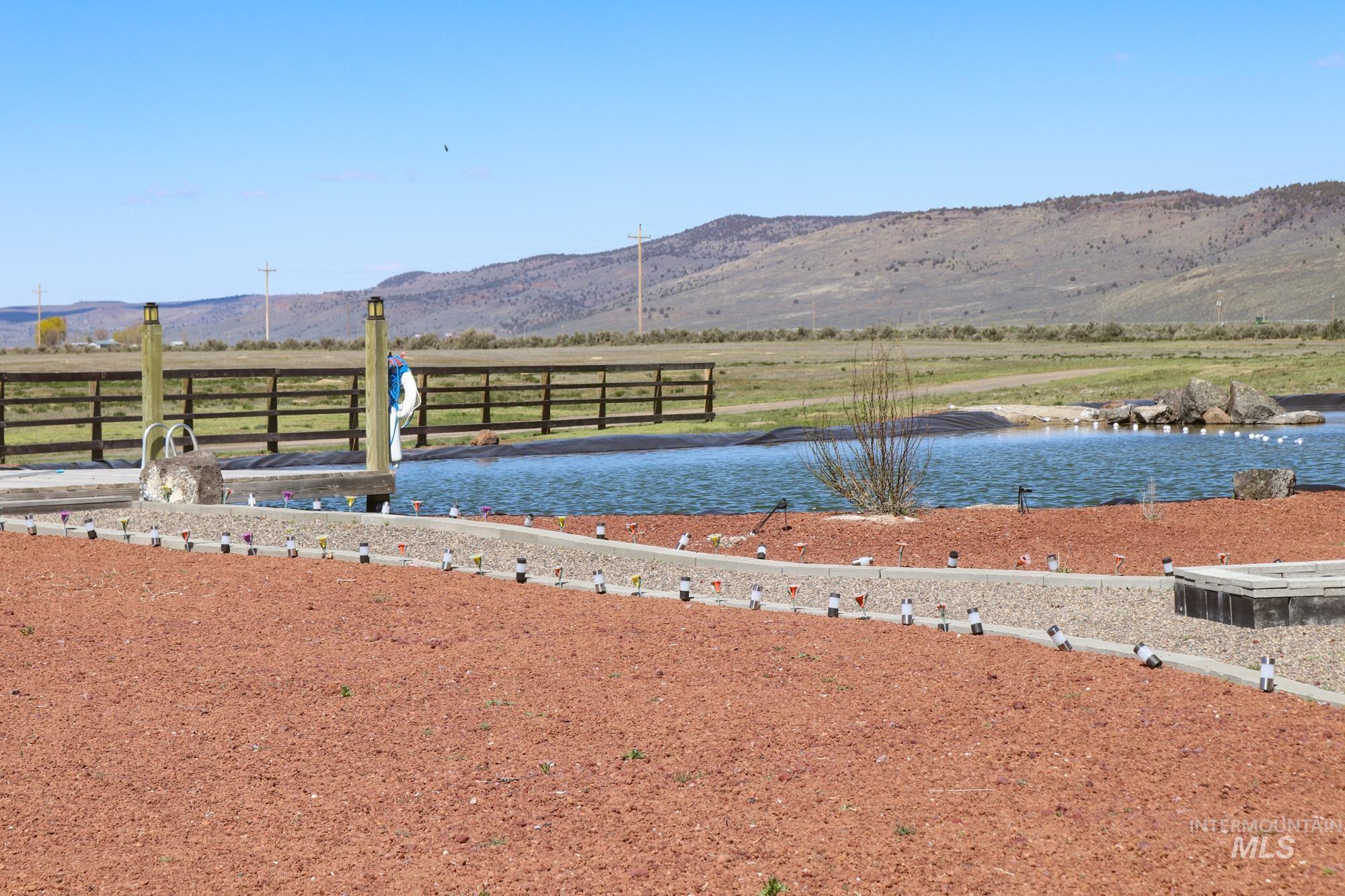 View of yard featuring a water and mountain view and a view of countryside