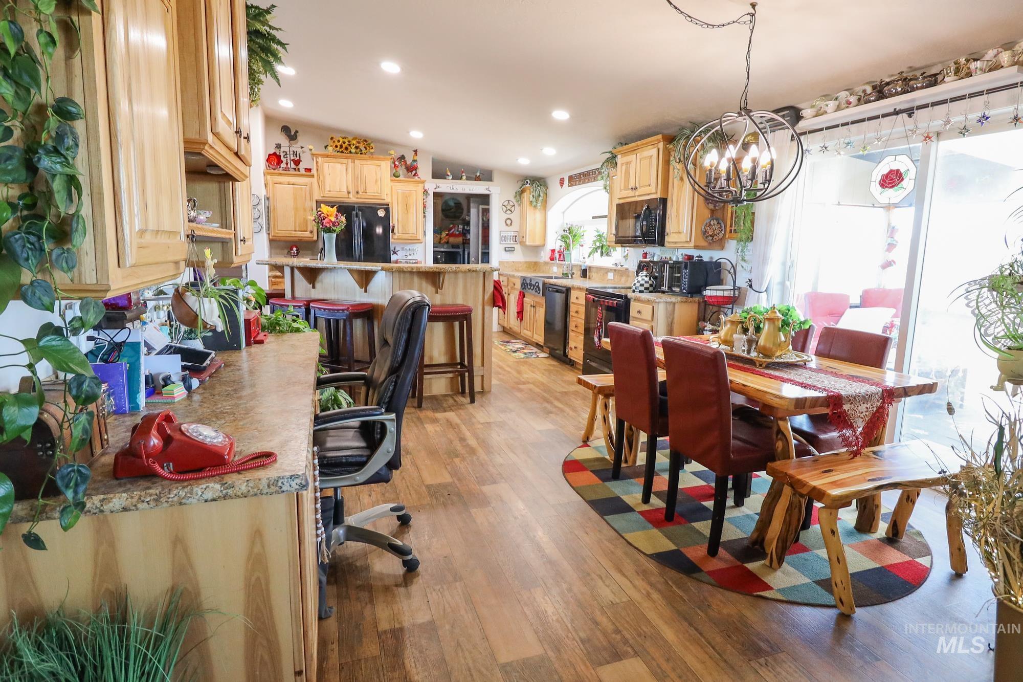 Dining room with a chandelier, light wood-type flooring, and recessed lighting