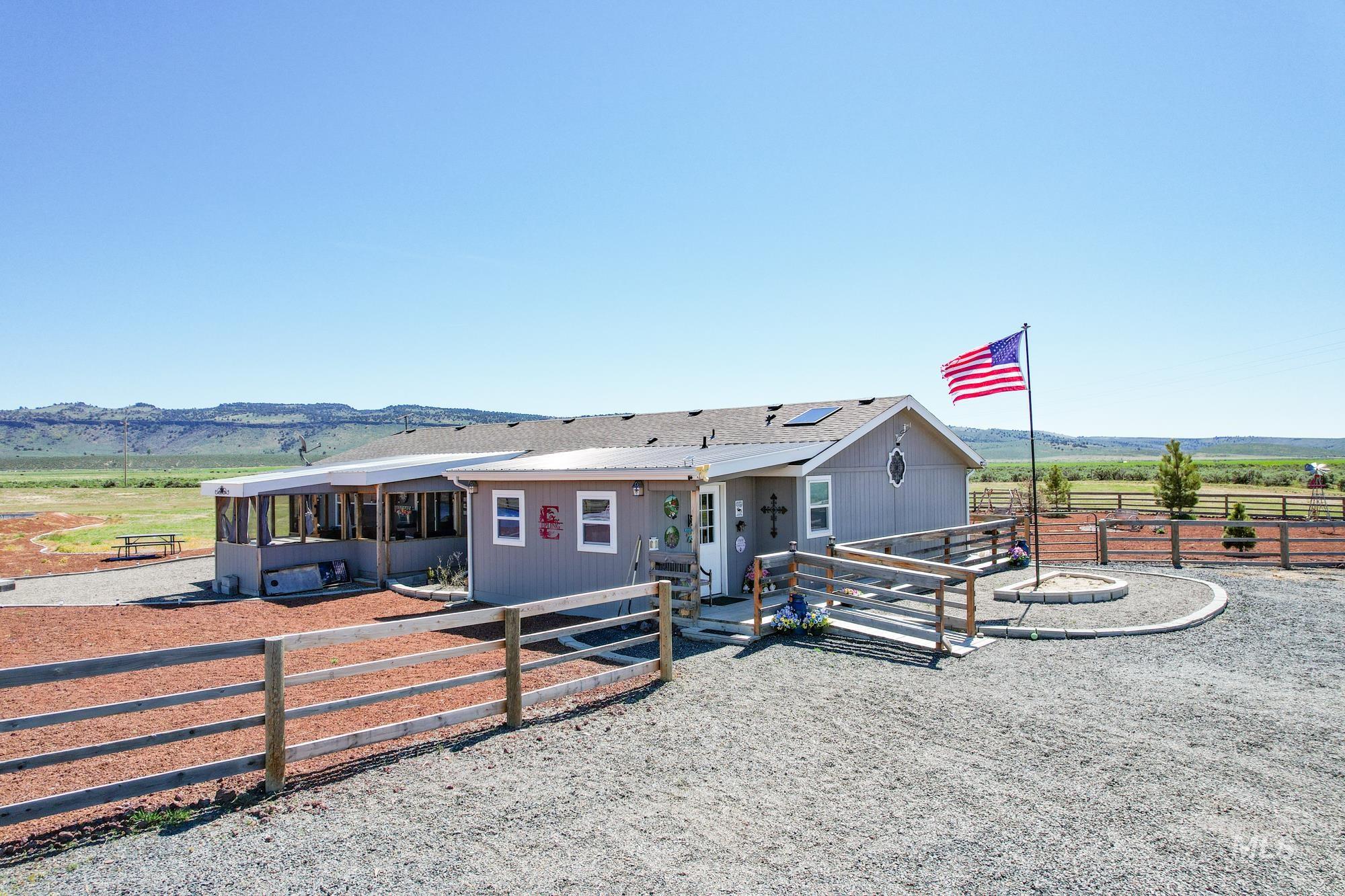 View of front of house featuring an exterior structure and roof mounted solar panels