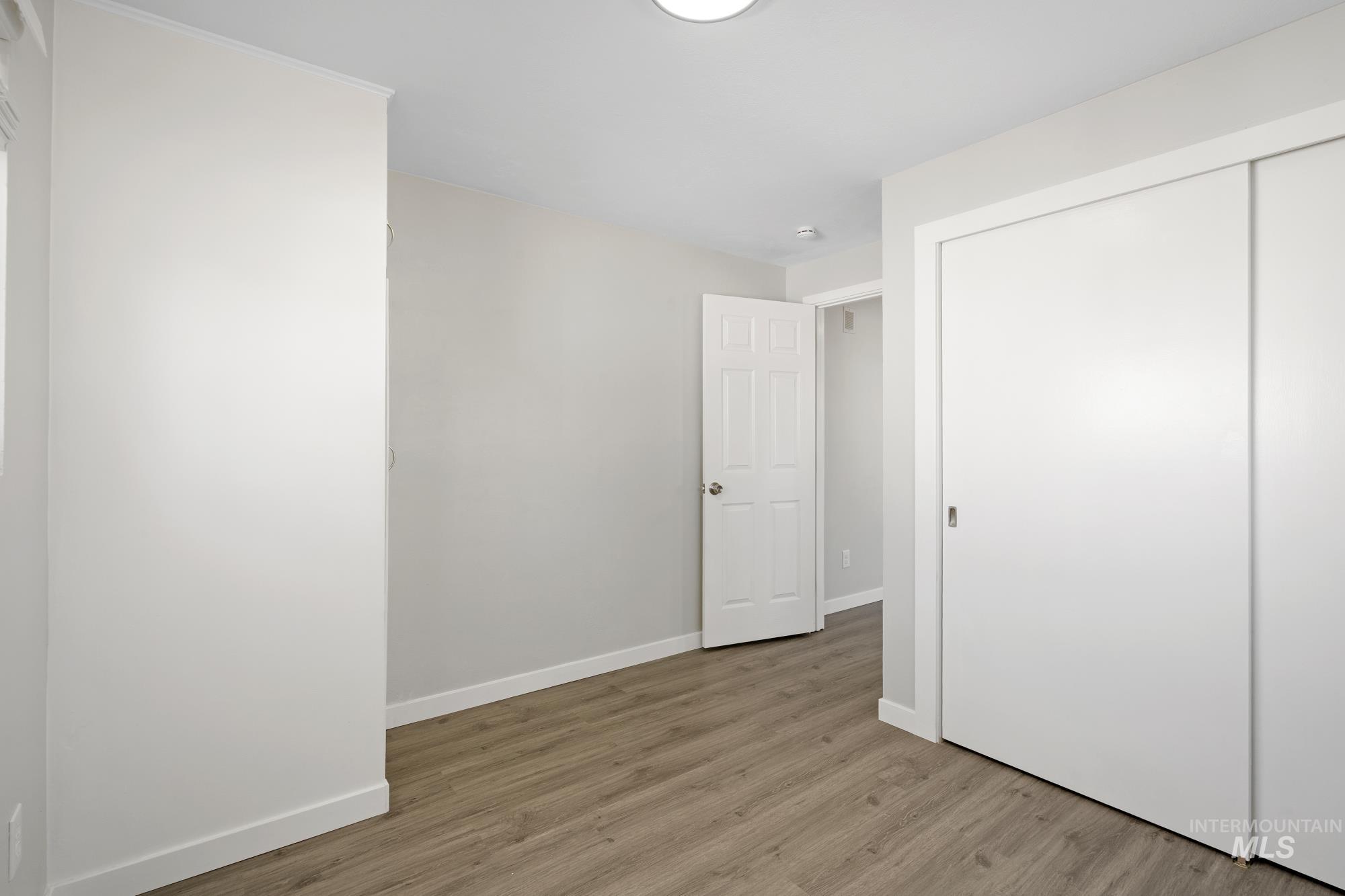 Unfurnished bedroom with light wood-style flooring and a closet