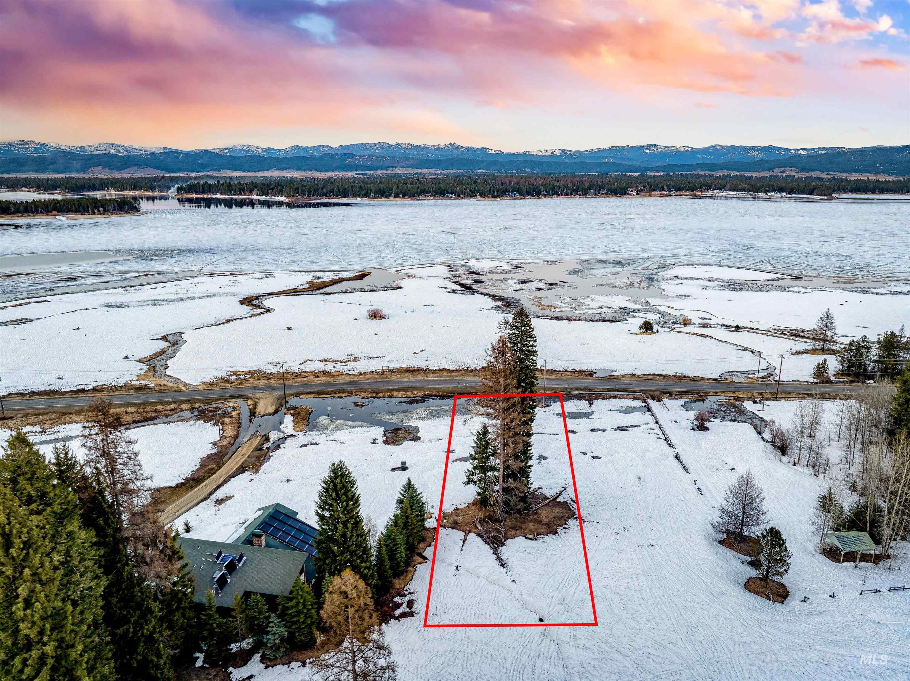 Snowy aerial view featuring property boundaries highlighted and a mountain view