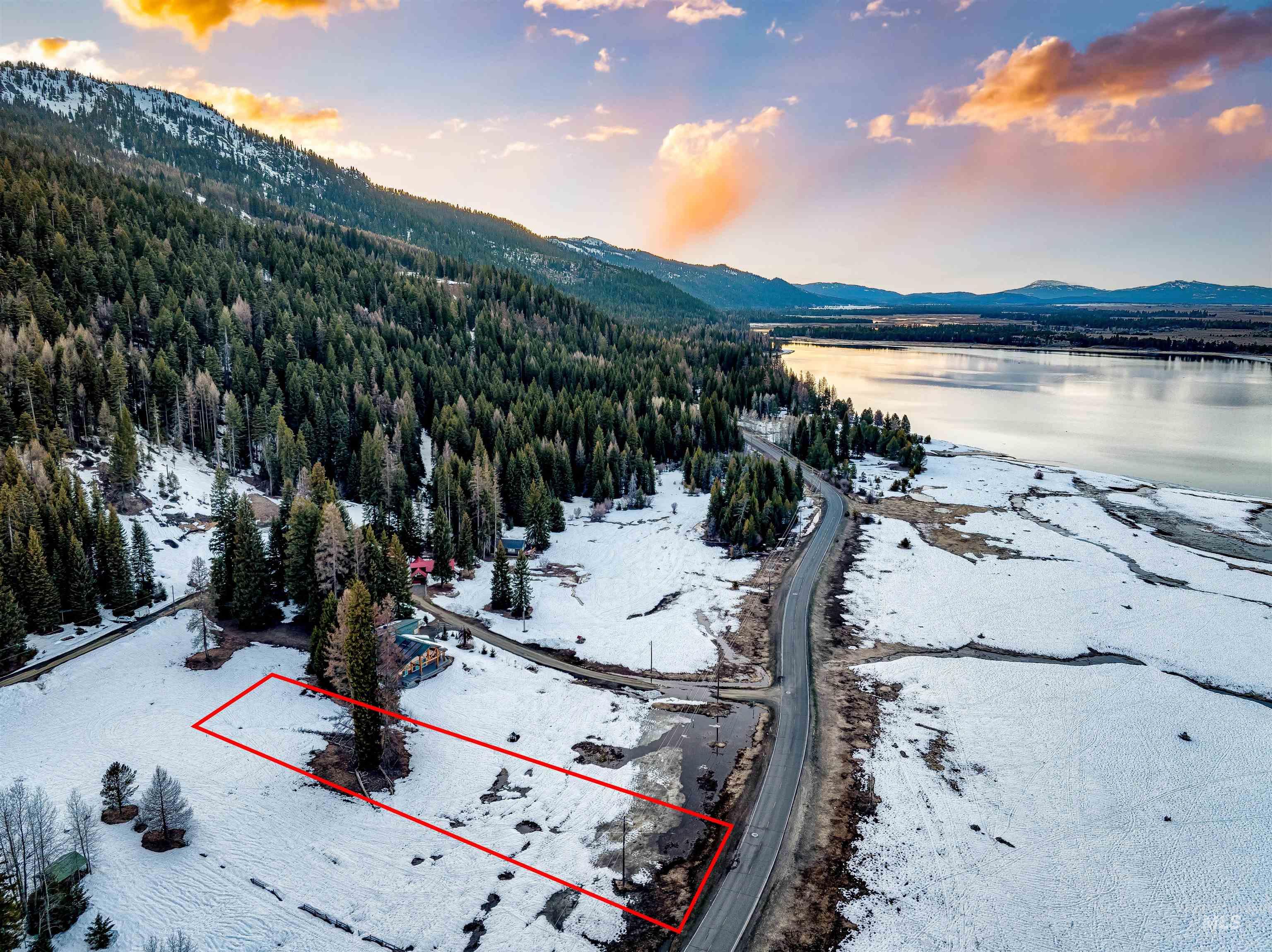 Aerial view at dusk of property boundaries highlighted and a water and mountain view