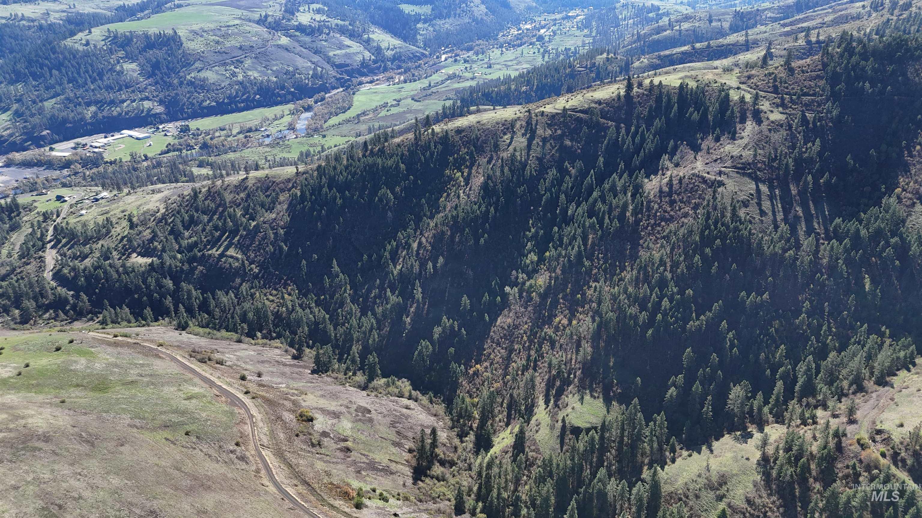 Aerial overview of property's location featuring a heavily wooded area