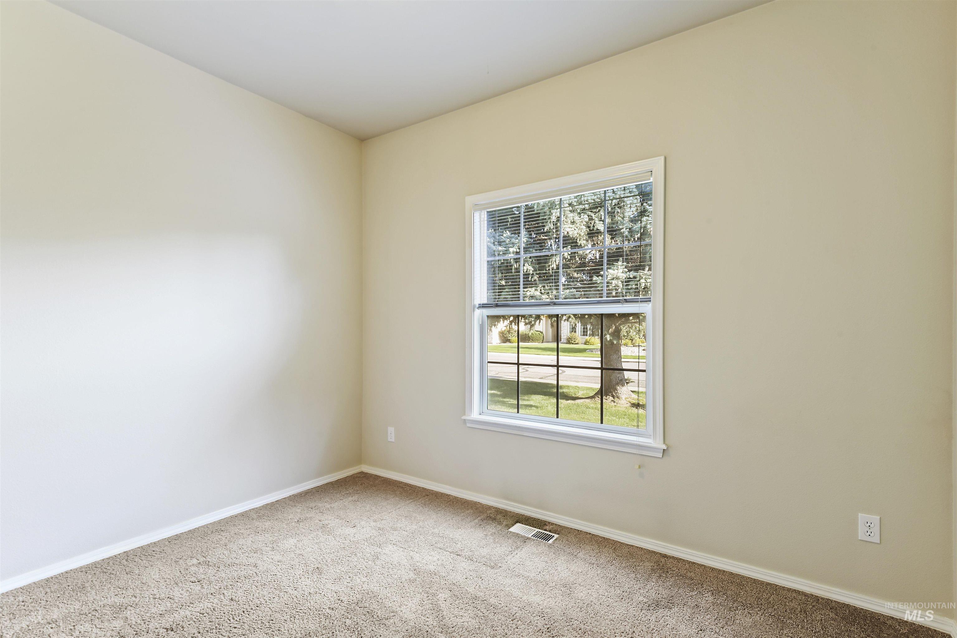 Carpeted empty room with baseboards