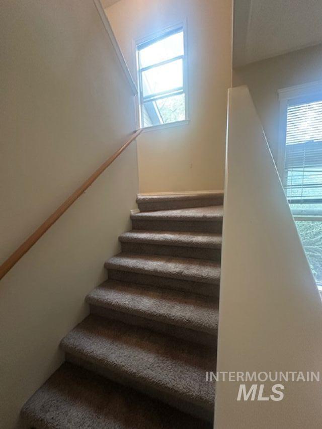 Stairway featuring plenty of natural light