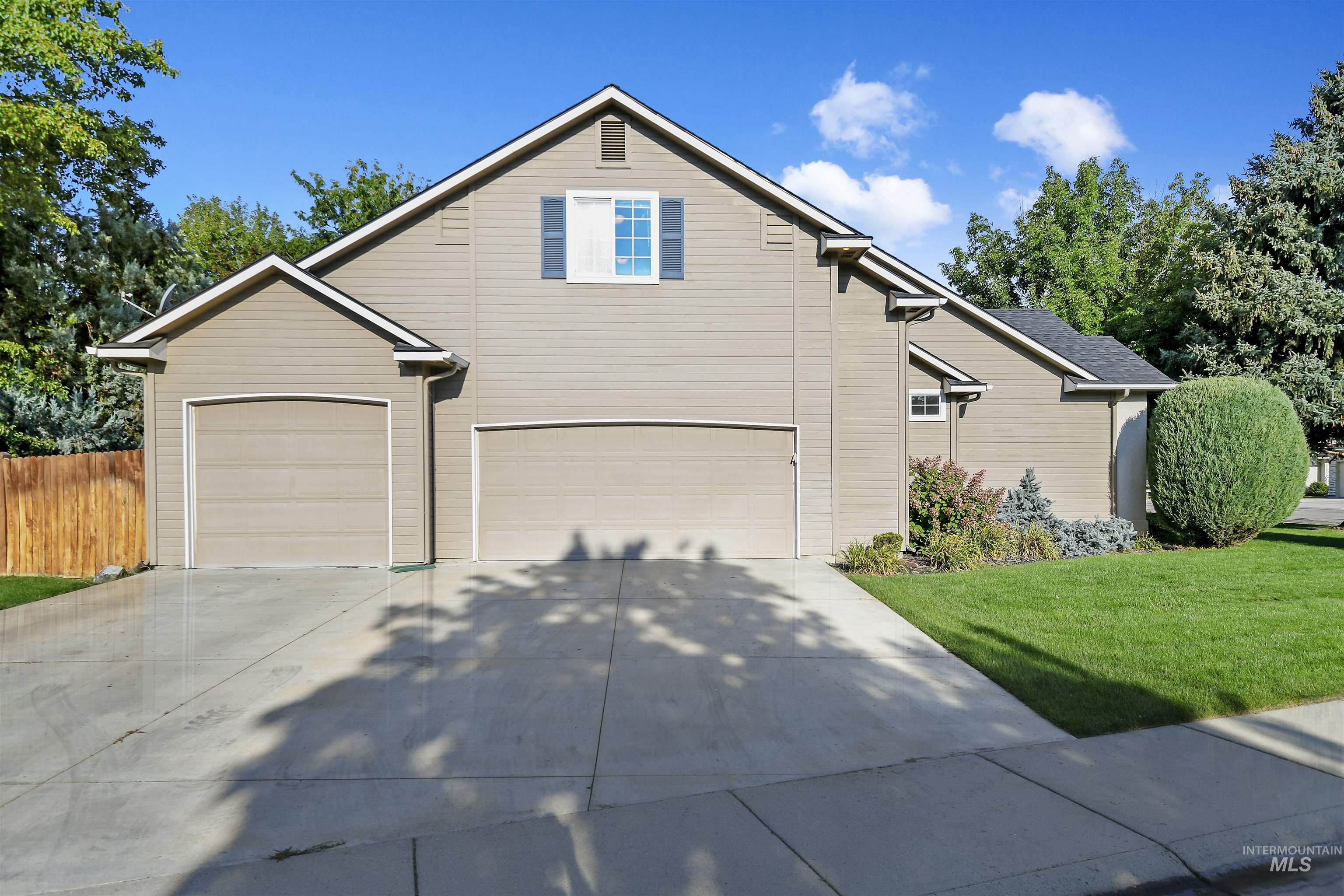 Traditional home featuring concrete driveway and a garage