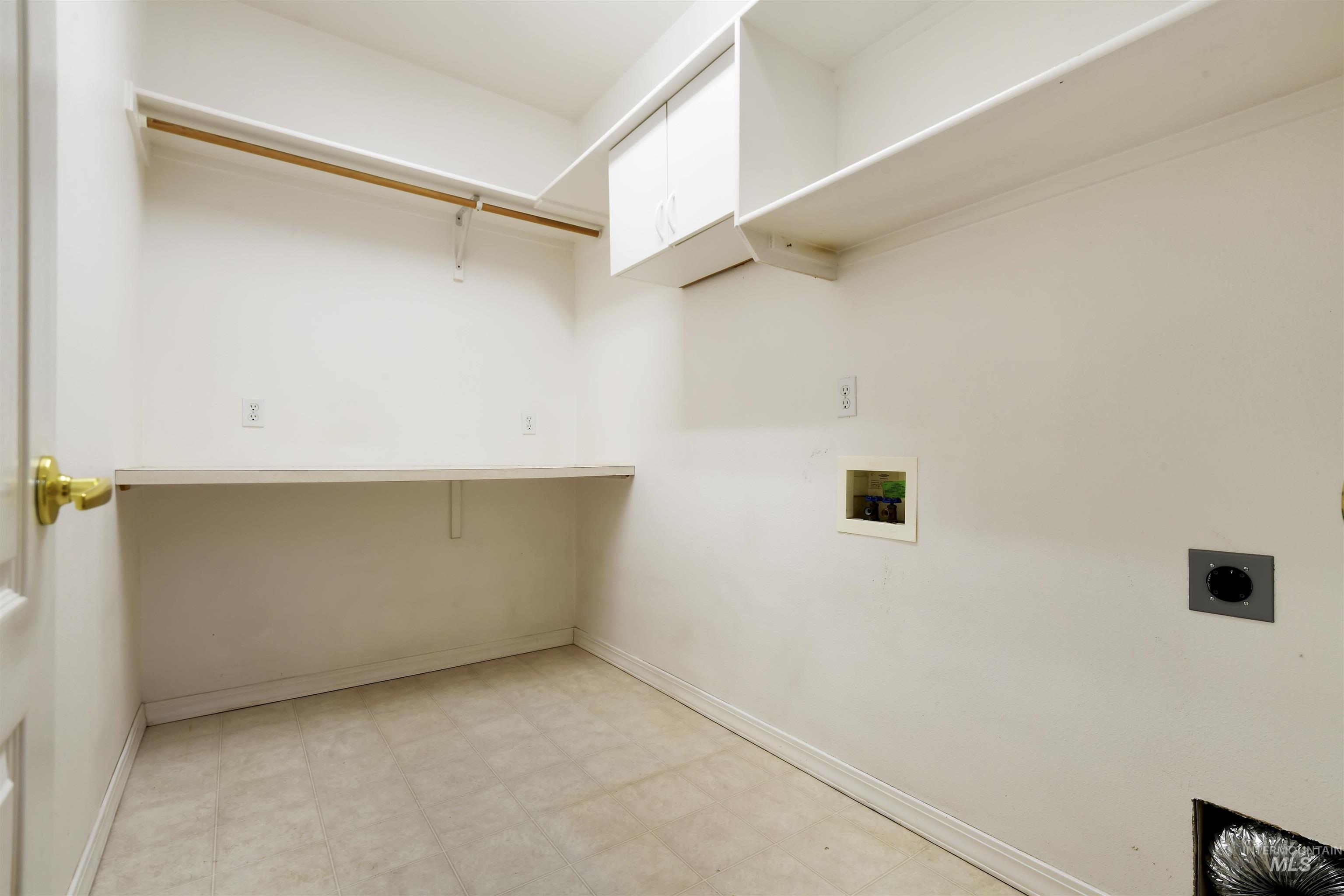 Laundry area featuring light flooring, washer hookup, and hookup for an electric dryer