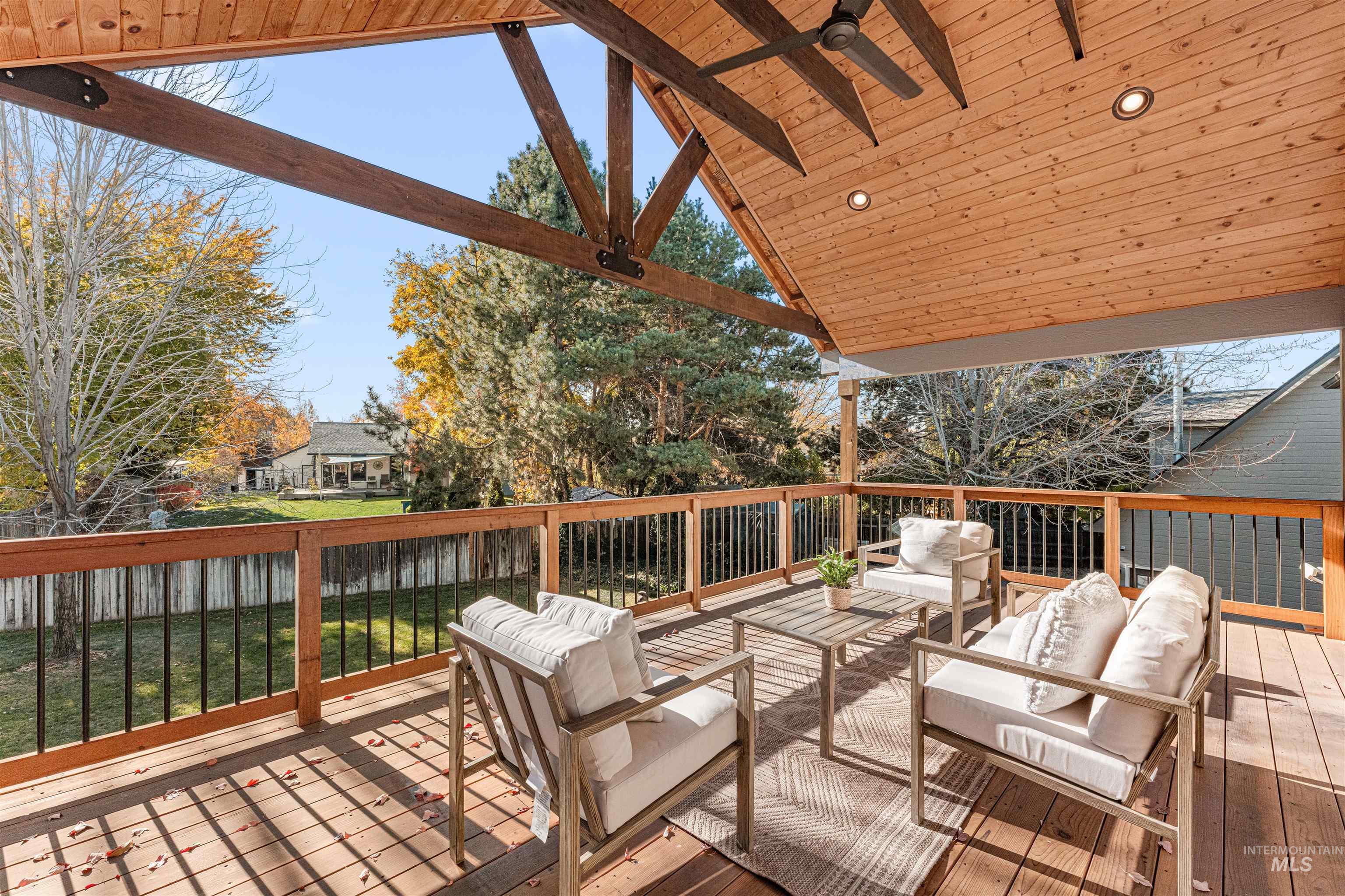 Deck with an outdoor living space and a ceiling fan