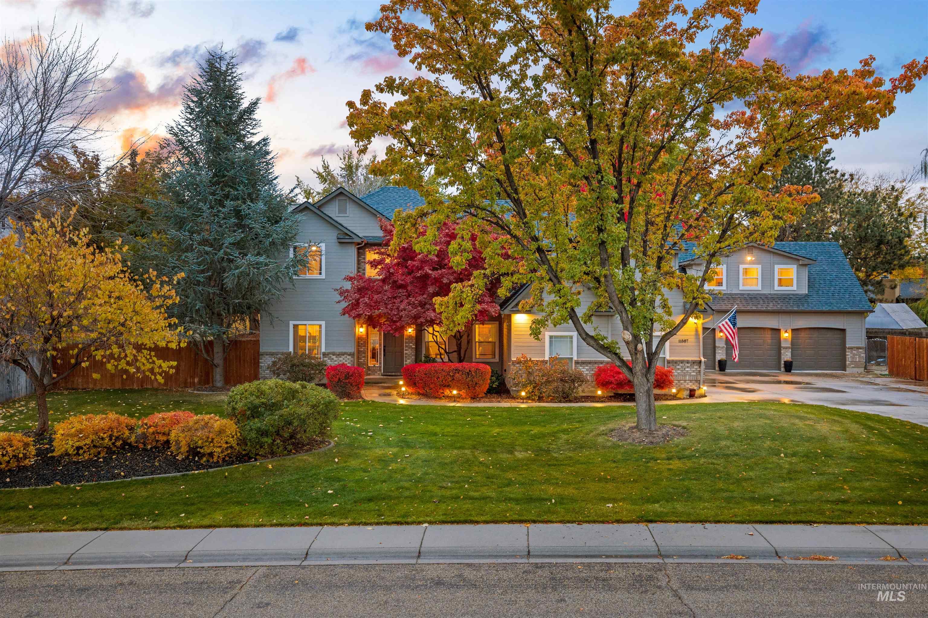 Obstructed view of property with a garage and driveway