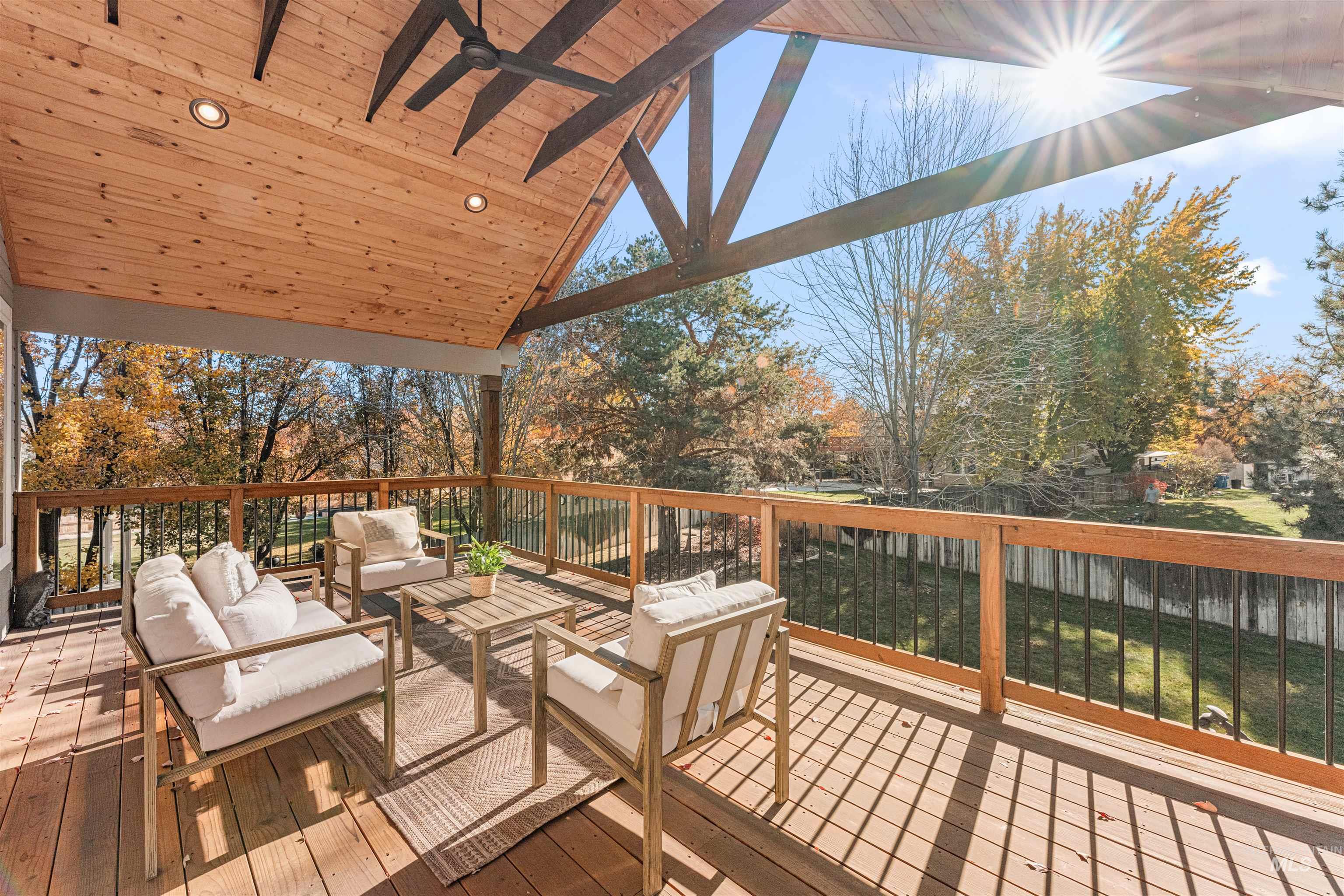 Deck with a ceiling fan and outdoor lounge area