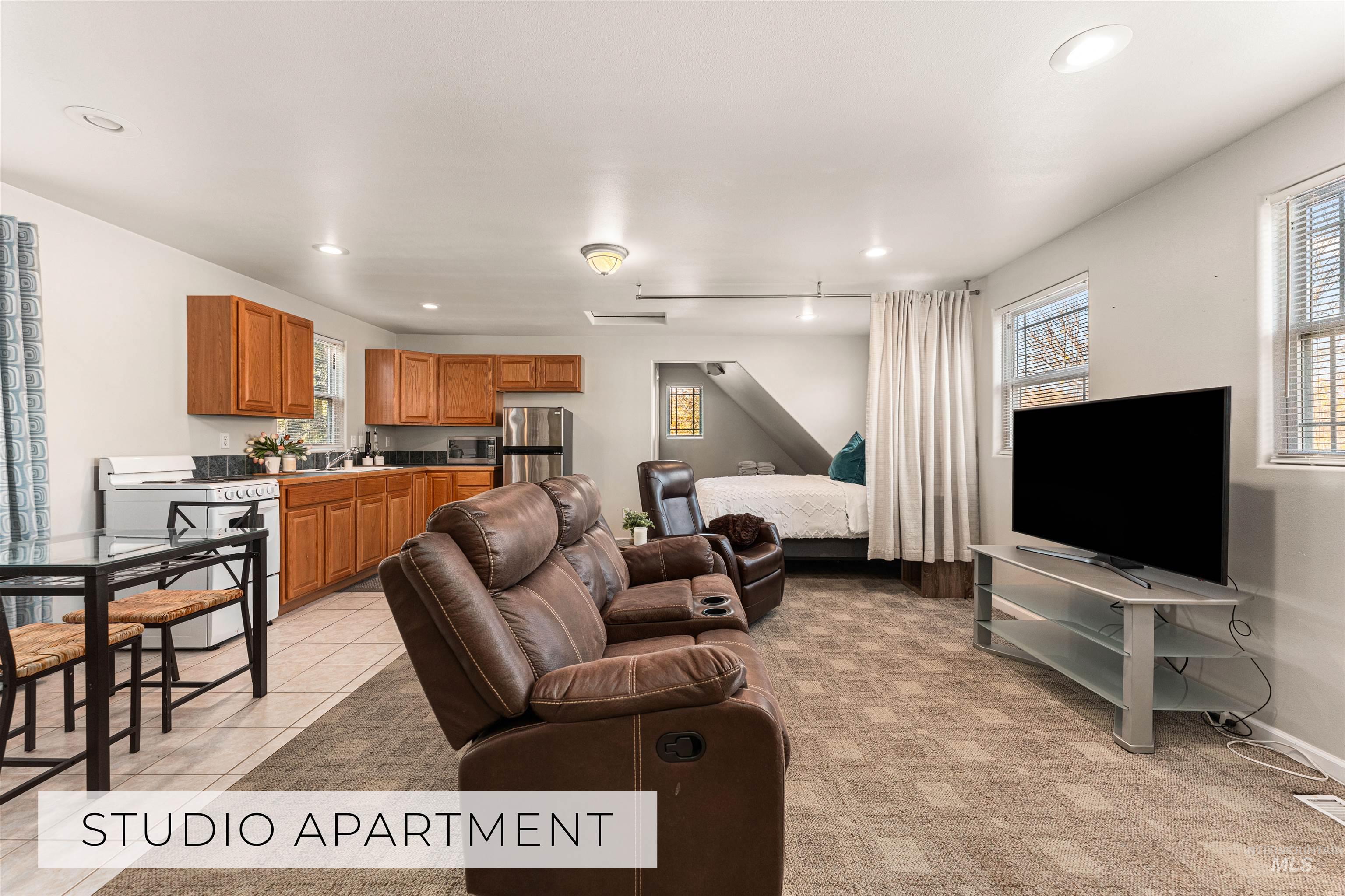 Living area featuring healthy amount of natural light, recessed lighting, and light tile patterned floors