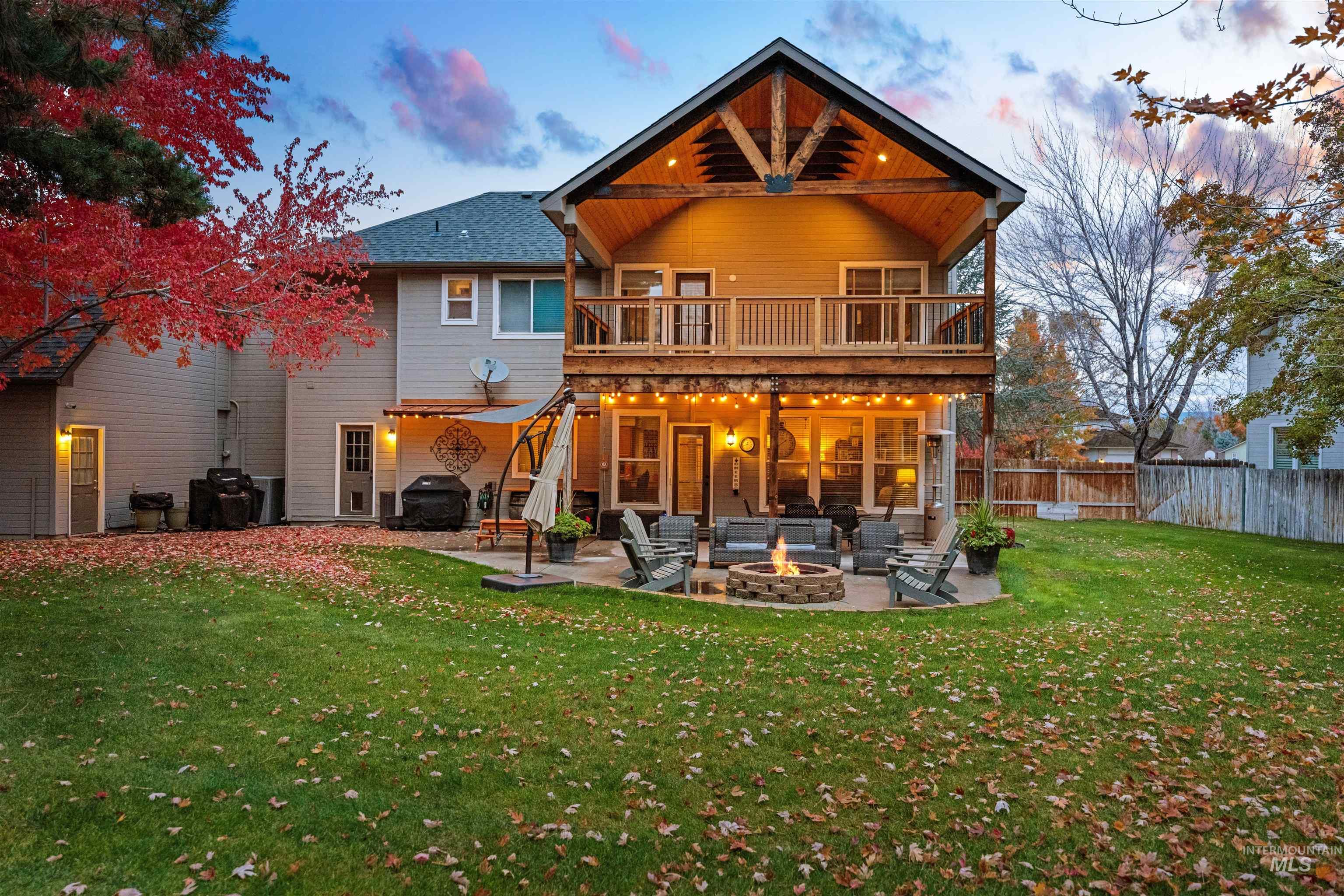 Rear view of house featuring a patio area and a fire pit