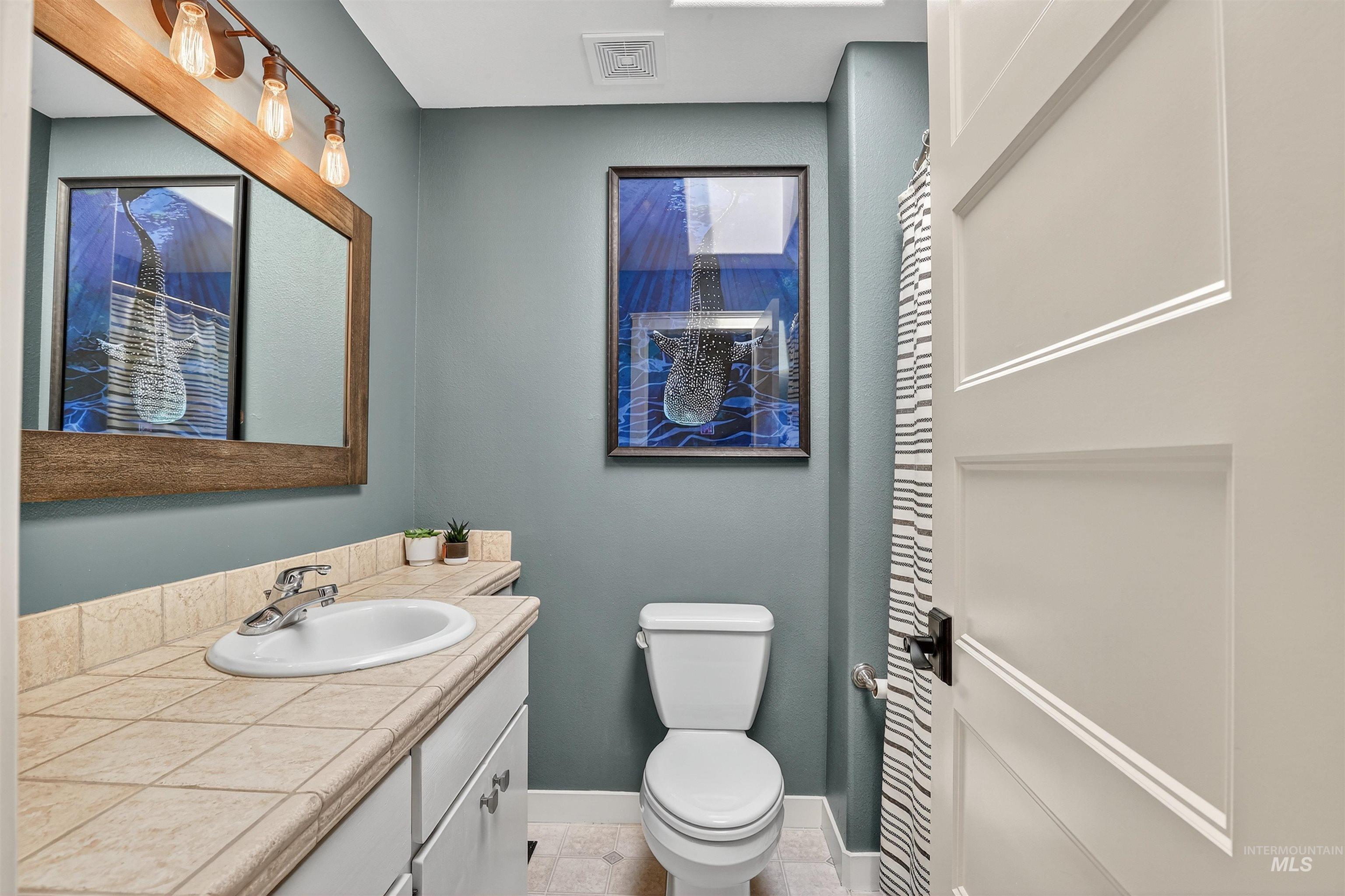 Bathroom featuring vanity and light tile patterned floors