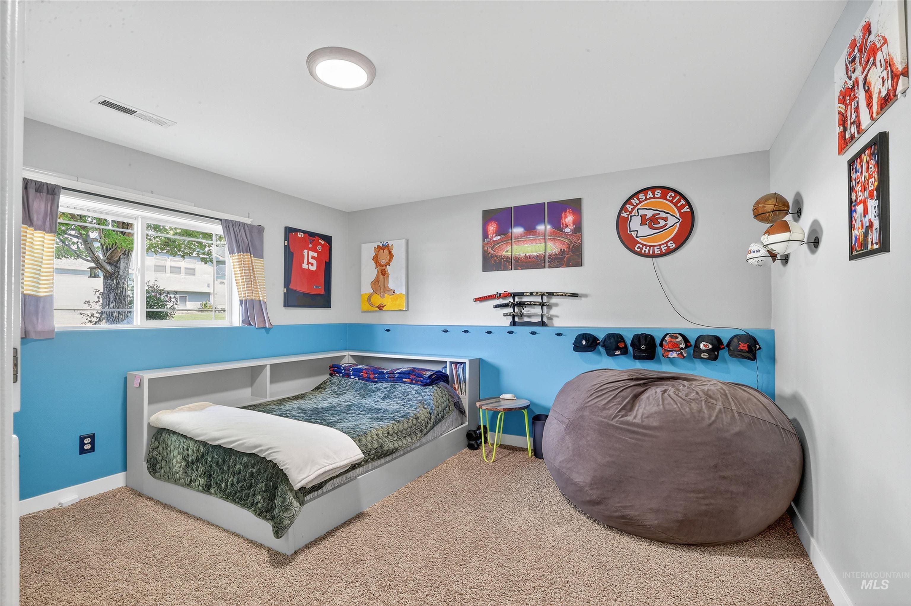 Bedroom featuring carpet floors and baseboards