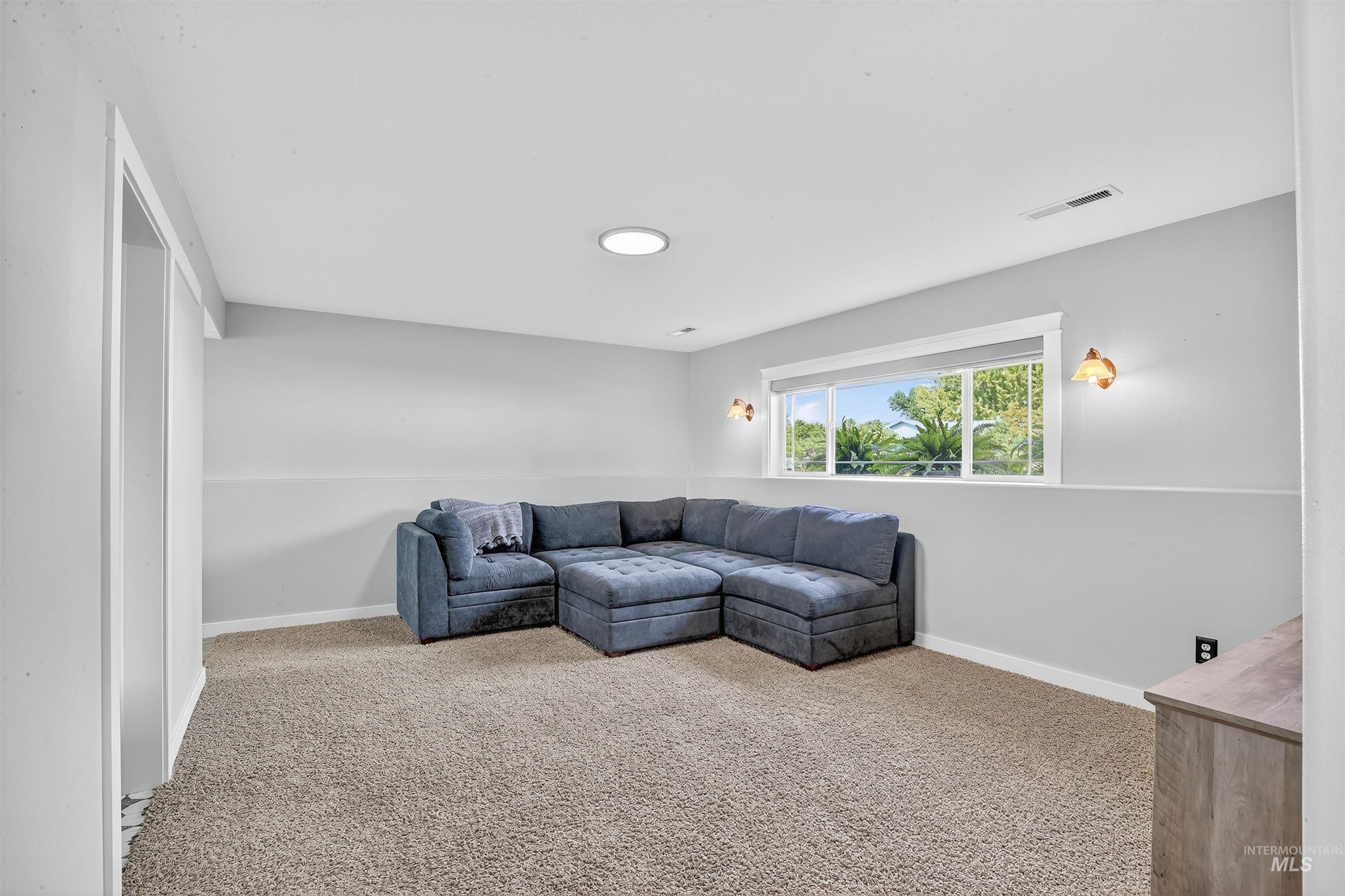 Living room featuring light carpet and baseboards