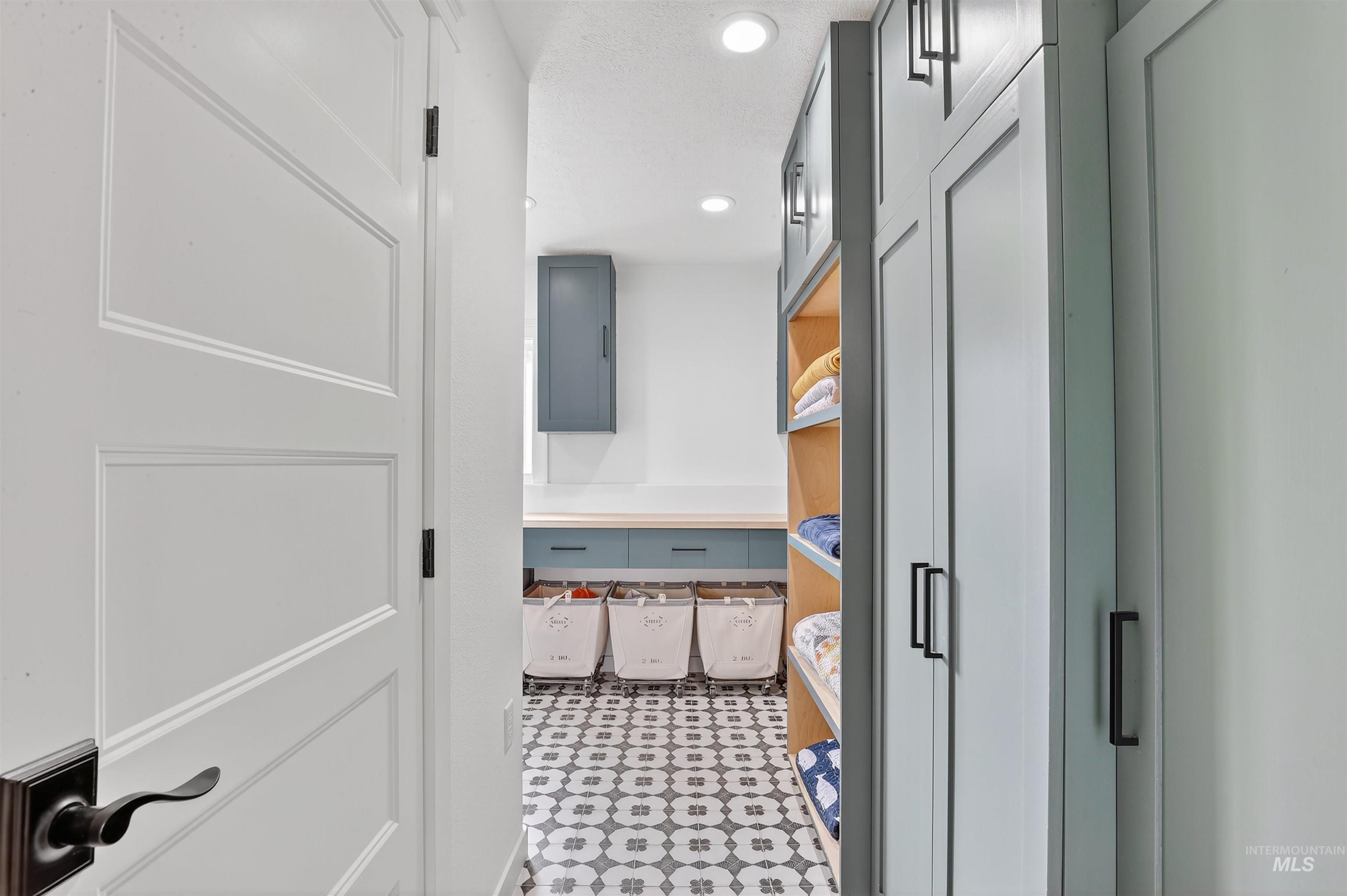 Bathroom with recessed lighting, electric panel, and light flooring